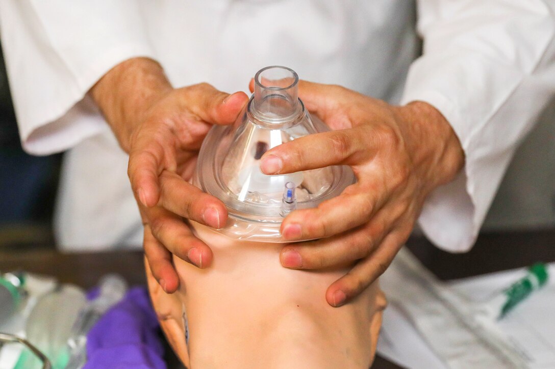 An Afghan medical staff member demonstrates airway clearance procedures on a mock casualty.