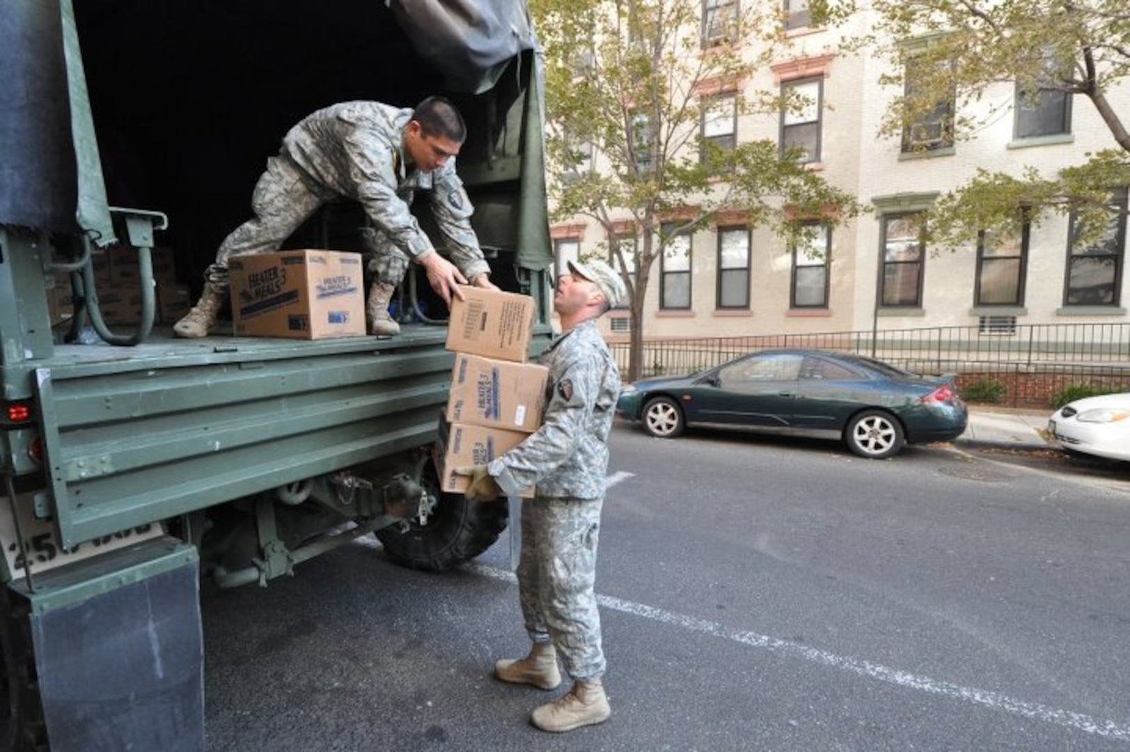 Army Sgt. Joseph Barbado, right, a New Jersey National Guard Soldier, unloads heater meals from a five-ton truck at a distribution point in Hoboken, Nov. 5.