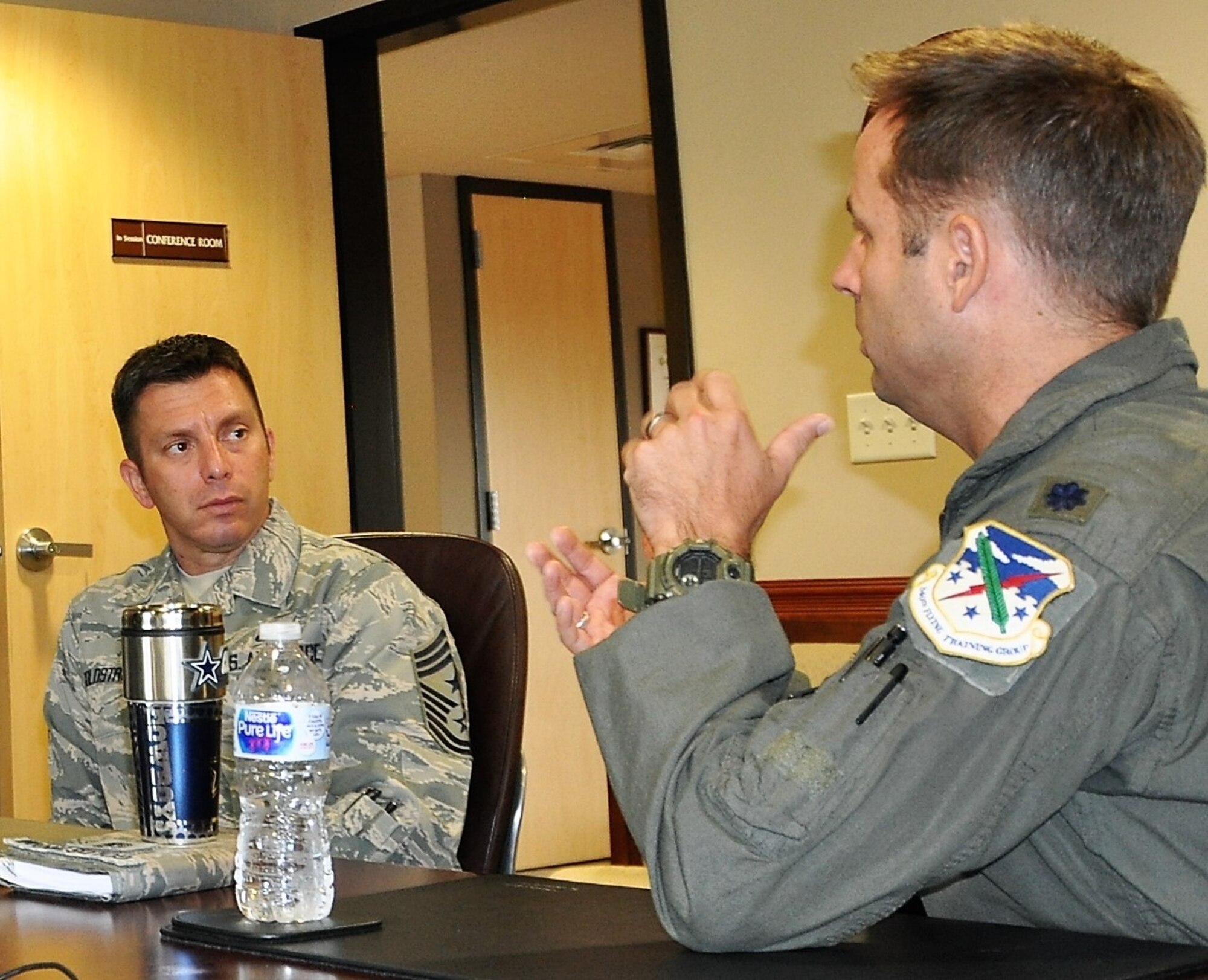 Lt. Col. Kyle Goldstein, 39th FTS commander chats with Chief Master Sgt. Antonio Goldstrom, 12th FTW command chief about the value the 39th adds to the 12th FTW mission during 12th FTW Commander Mark Robinson’s Aug. 9 immersion visit to the 340th FTG  at Joint Base San Antonio-Randolph, Texas. (U.S. Air Force photo by Janis El Shabazz)