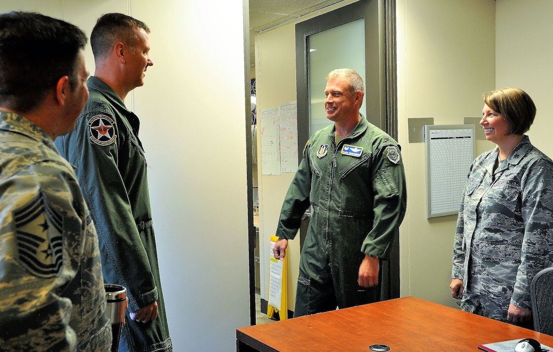 Col. Mark Robinson, 12th FTW Commander, discusses process improvement methods with Col. Allen Duckworth, 340th FTG Commander (center), Lt. Col. Sara Linck, 340th FTG continuous process improvement manager, and Chief Master Sgt. Antonio Goldstrom, 12th FTW Command Chief during Robinson’s visit to the unit at Joint Base San Antonio-Randolph, Texas for an immersion brief on Aug. 9. (U.S. Air Force photo by Janis El Shabazz)