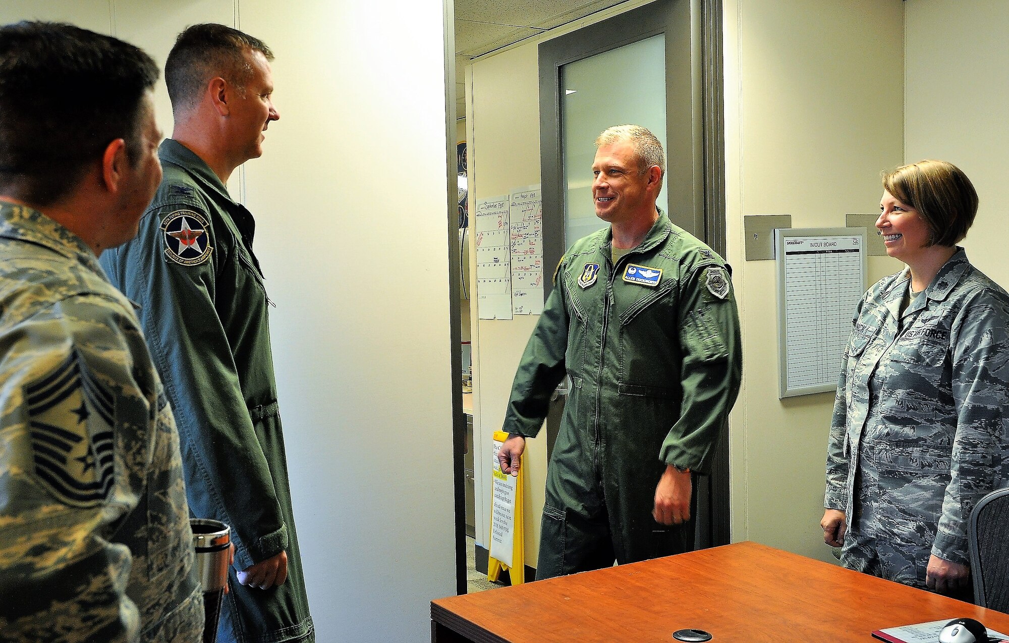 Col. Mark Robinson, 12th FTW Commander, discusses process improvement methods with Col. Allen Duckworth, 340th FTG Commander (center), Lt. Col. Sara Linck, 340th FTG continuous process improvement manager, and Chief Master Sgt. Antonio Goldstrom, 12th FTW Command Chief during Robinson’s visit to the unit at Joint Base San Antonio-Randolph, Texas for an immersion brief on Aug. 9. (U.S. Air Force photo by Janis El Shabazz)