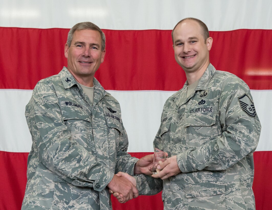 Master Sgt. Steve Hager, 934th Explosive Ordnance Disposal, receives the Senior NCO of the Quarter award from Col. Tim Wollmuth, 934 AW vice commander, Aug. 5. (Air Force Photo/Tech. Sgt. Amber E.N. Jacobs)