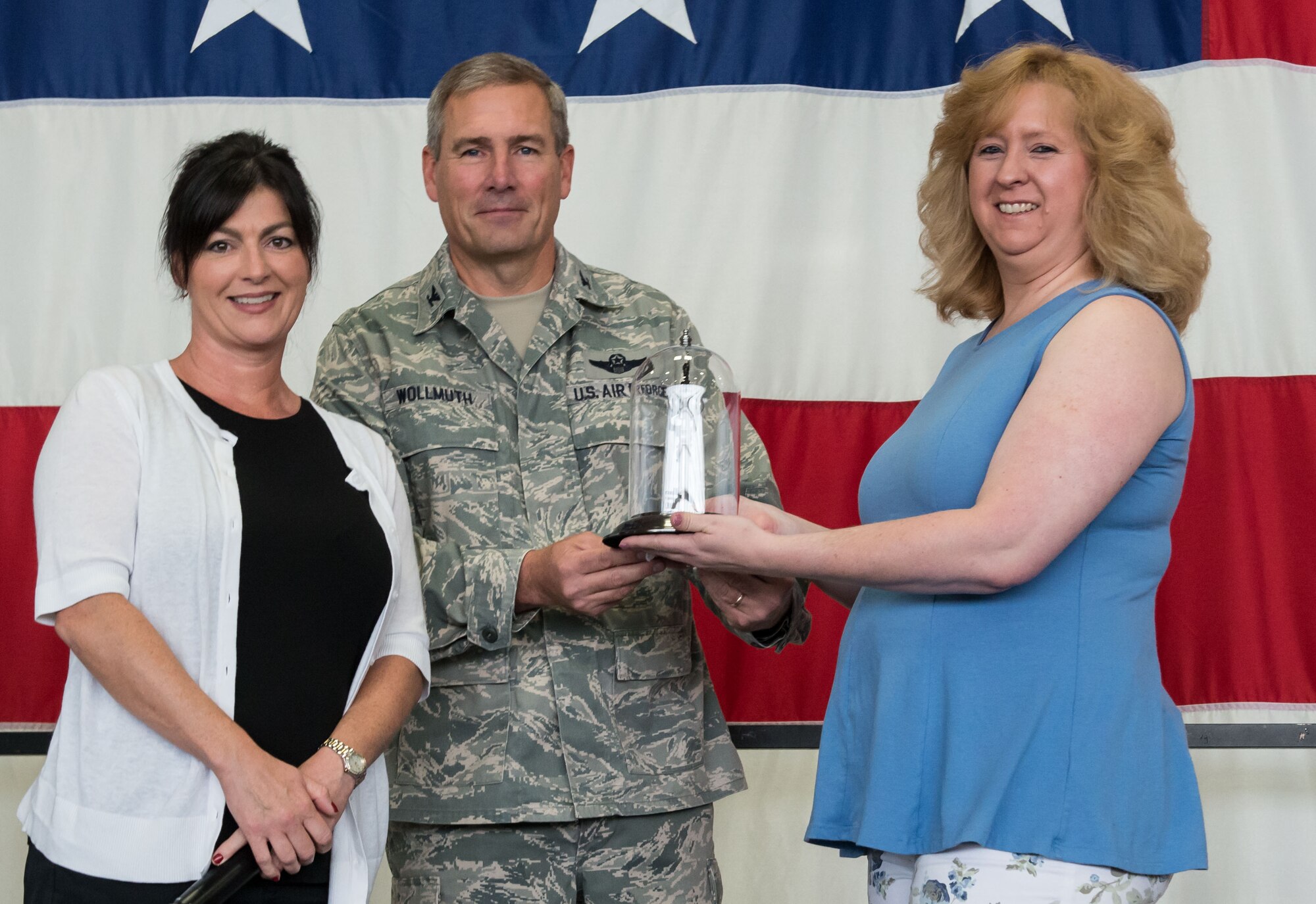 Lynn Amidon (right) is recognized by Col. Tim Wollmuth, 934th Airlift Wing vice commander, and Dina Landsberger for her two years service as director of the 934th Airlift Wing Key Spouse program. Ms. Tami DiGiovanni will take over as the new director. (Air Force Photo/Tech. Sgt. Amber Jacobs)