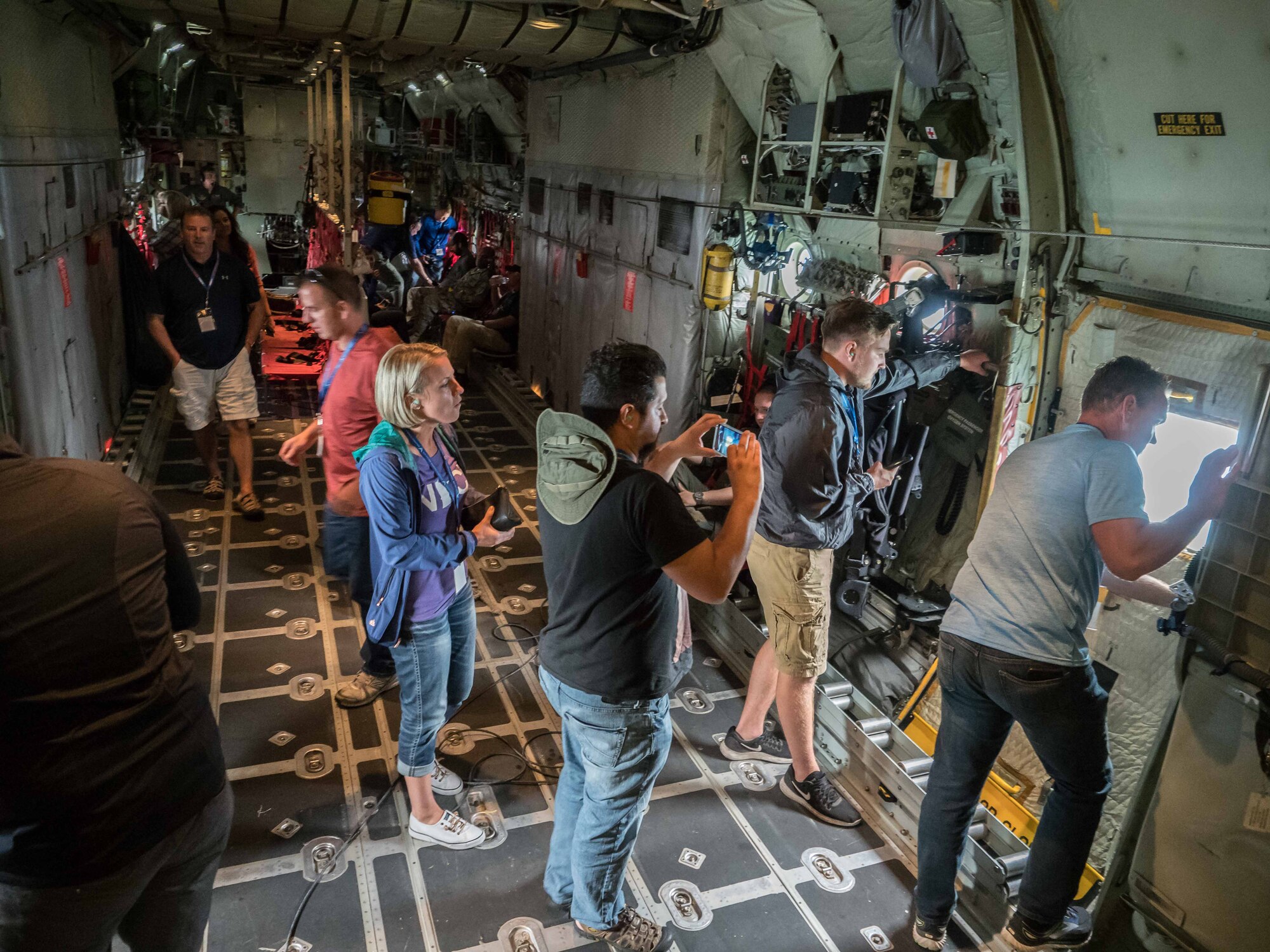 Employers peer out the windows of the cargo section of a C-130 during a flight on Employers Day Aug. 4. (Air Force Photo/Paul Zadach)