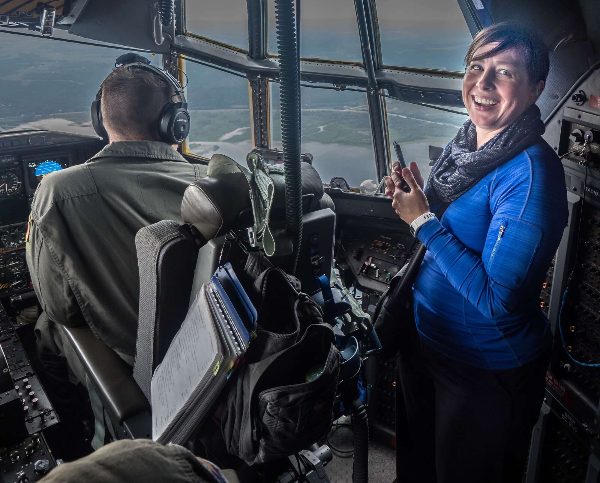 Lindsay Hammond from KL Discovery enjoys the view from the C-130 cockpit. (Air Force Photo/Paul Zadach)