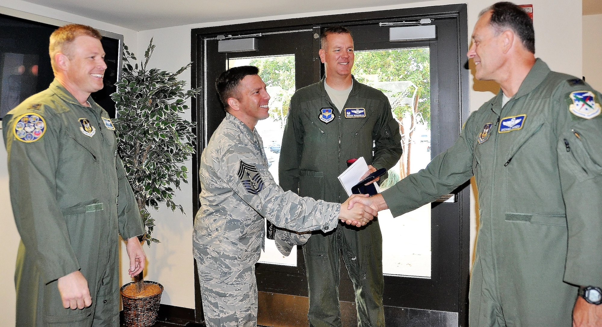 340th Flying Training Group Commander Col. Allen Duckworth (left) and 340th FTG Director of Operations Michael Vanzo welcome 12th Flying Training Wing Commander Col. Mark Robinson and 12th FTW Command Chief, Chief Master Sgt. Antonio Goldstrom for an Aug. 9 unit immersion briefing at Joint Base San Antonio-Randolph, Texas. (U.S. Air Force photo by Janis El Shabazz)