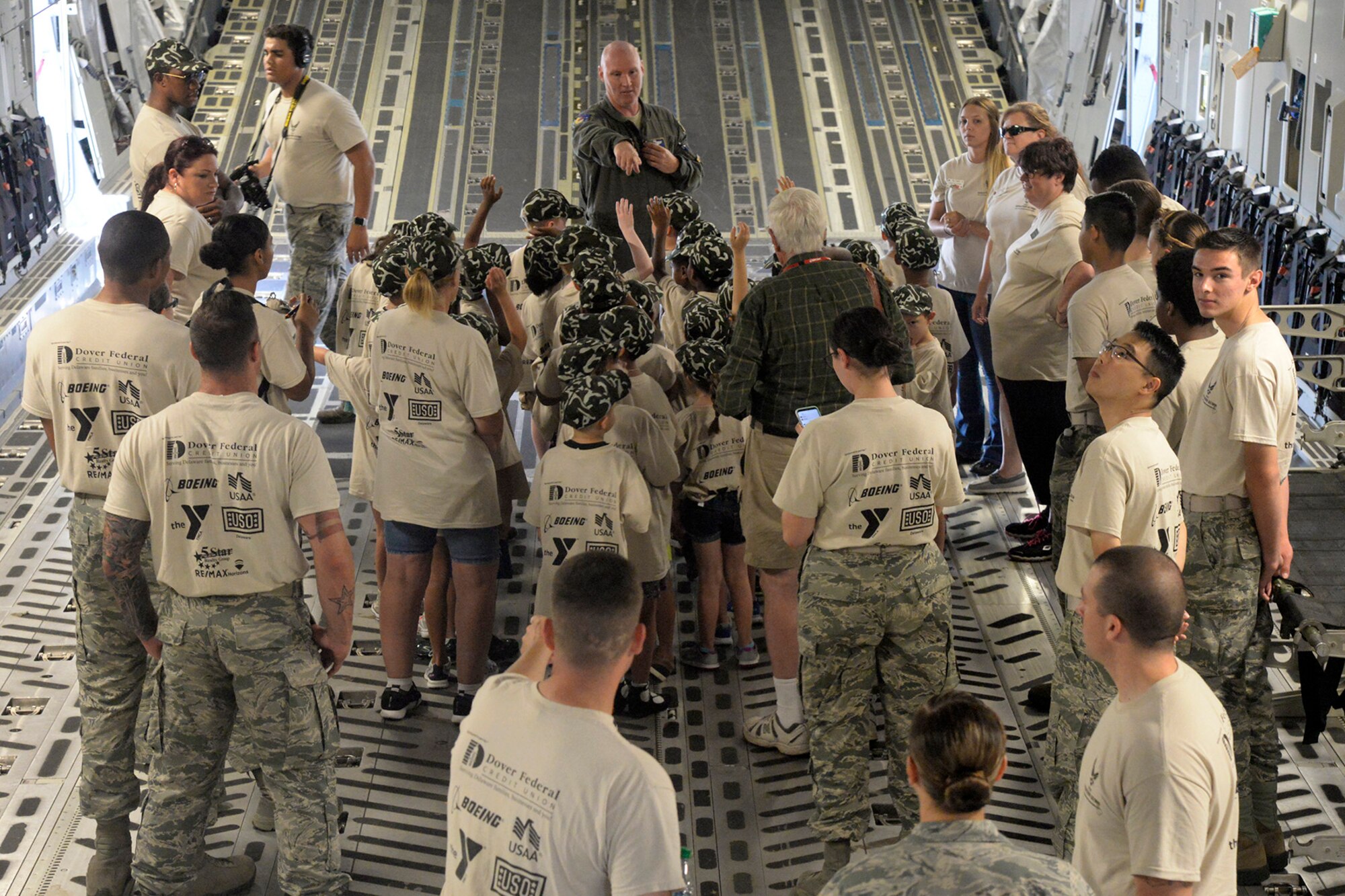 Tech. Sgt. Chris Koch, 3rd Airlift Squadron loadmaster, explains mobility operations to children aboard a static C-17 Globemaster III during a Kids/Teachers Understanding Deployment Operations event Aug. 9, 2018, at Dover Air Force Base, Del. Children and teachers got to see how mobility Airmen deploy around the world and what equipment is used to get them there. (U.S. Air Force photo by Tech. Sgt. Matt Davis)