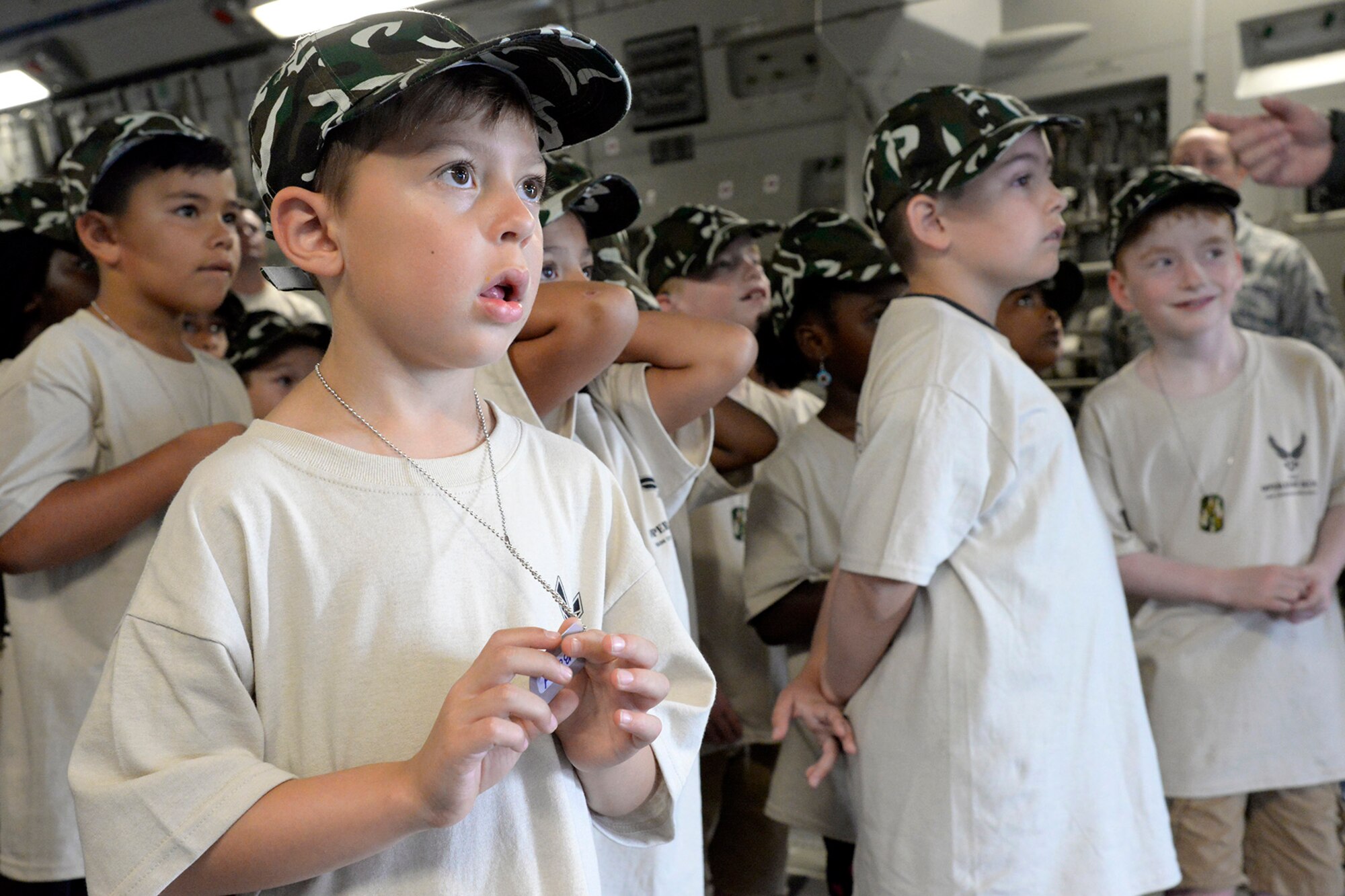 Children observe mobility Airmen operate load equipment aboard a static C-17 Globemaster III during a Kids/Teachers Understanding Deployment Operations event Aug. 9, 2018, at Dover Air Force Base, Del. School-aged children and teachers learned about the types of missions mobility Airmen support around the globe. (U.S. Air Force photo by Tech. Sgt. Matt Davis)