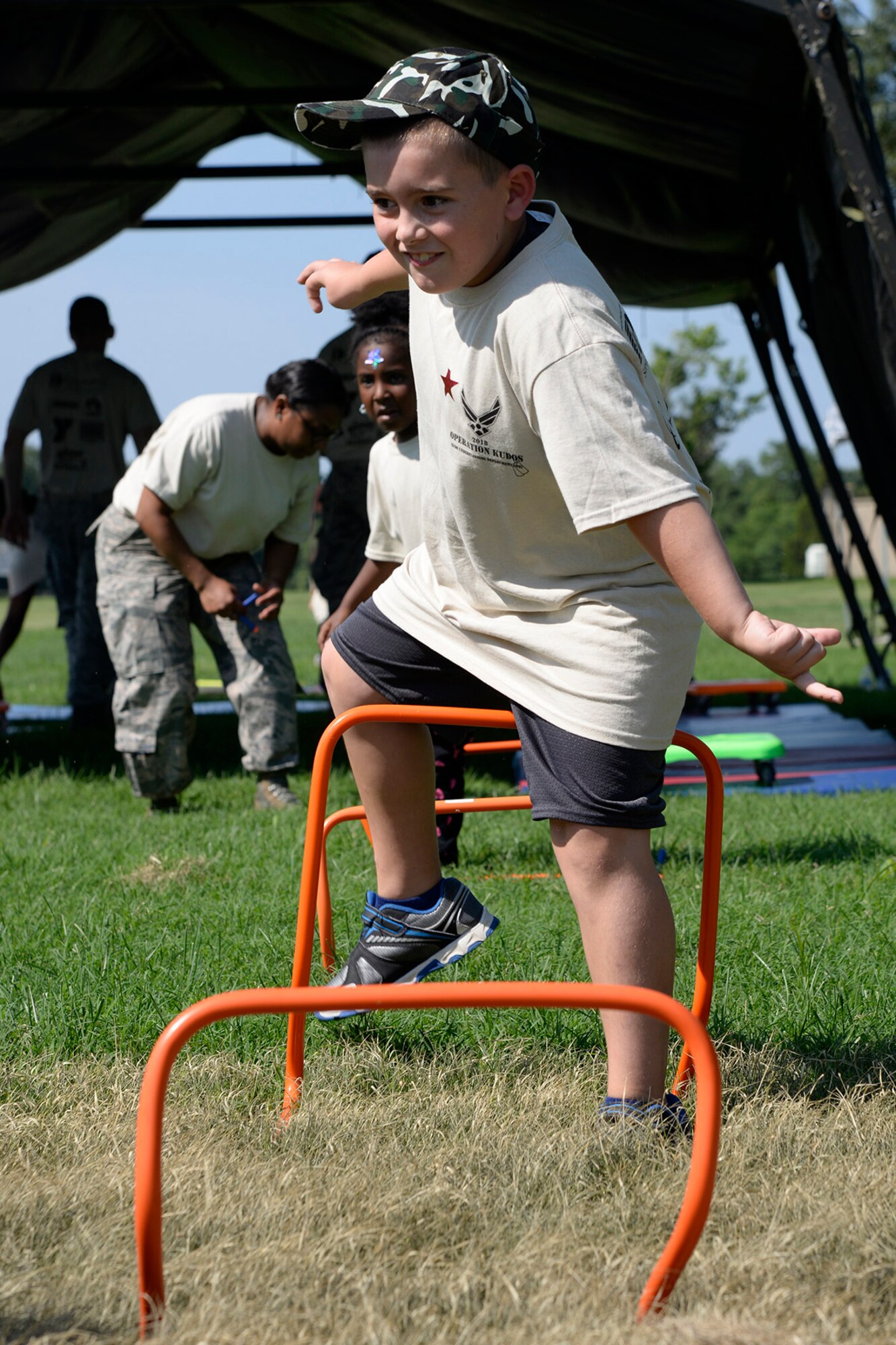 Children run through an obstacle course at the base youth center during a Kids/Teachers Understanding Deployment Operations event Aug. 9, 2018, at Dover Air Force Base, Del. Children and teachers simulated what it means to be combat fit for deployment operations. (U.S. Air Force photo by Tech. Sgt. Matt Davis)