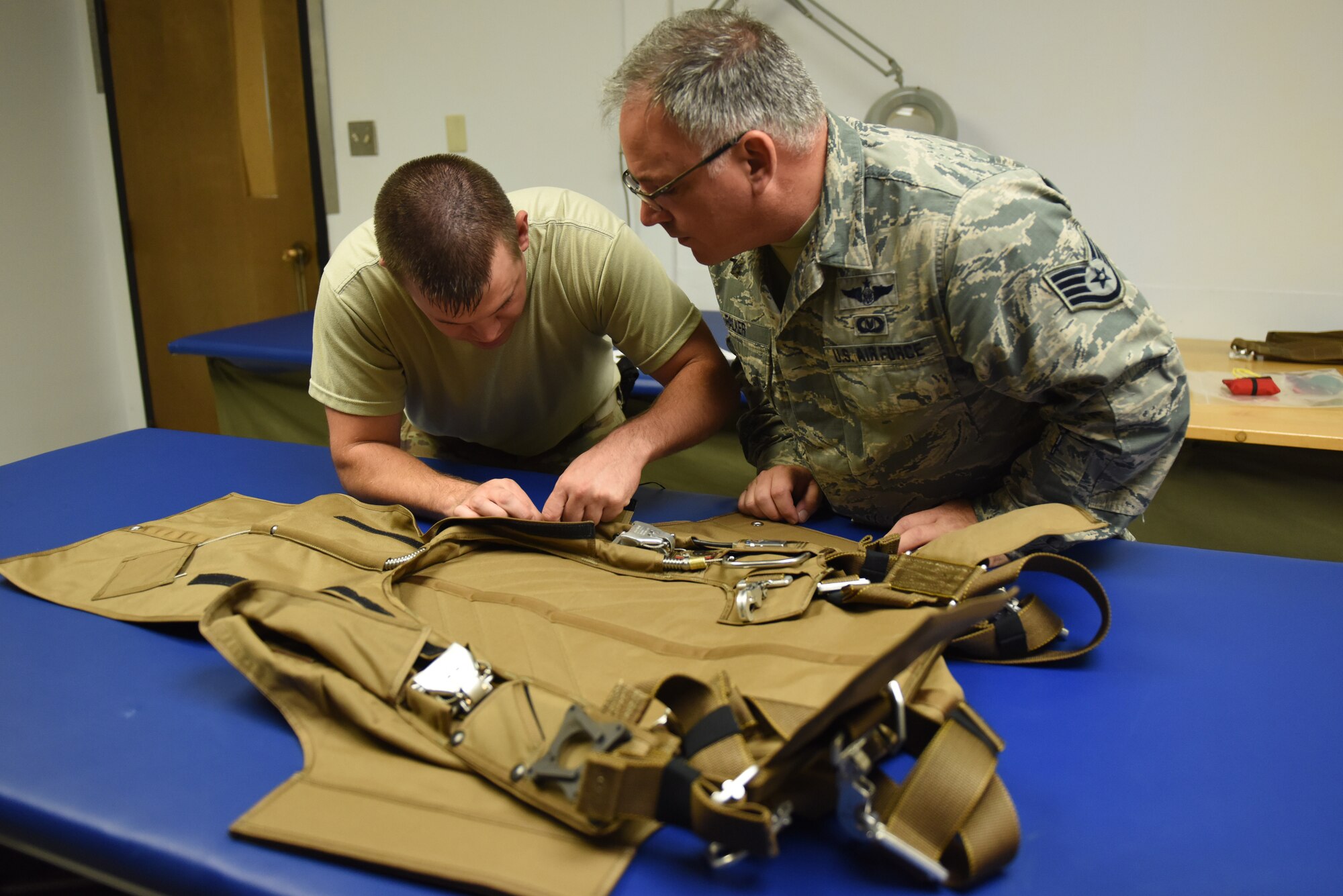 Tech. Sgt. Kurt Mellott and Staff Sgt. Stephen Falker, aircrew flight equipment technicians with the 193rd Special Operations Support Squadron, Middletown, Pennsylvania, Pennsylvania Air National Guard, build a Low-Profile Parachute from scratch Aug. 9, 2018. The new parachutes replaced the old ones, which were originally constructed in the 1980’s. (U.S. Air National Guard photo by Senior Airman Julia Sorber/Released)