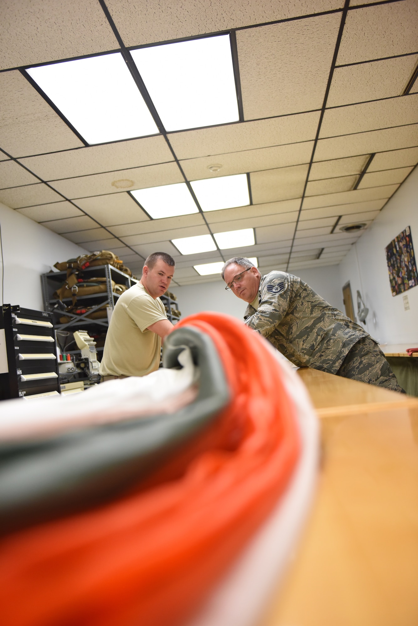 Tech. Sgt. Kurt Mellott and Staff Sgt. Stephen Falker, aircrew flight equipment technicians with the 193rd Special Operations Support Squadron, Middletown, Pennsylvania, Pennsylvania Air National Guard, build a Low-Profile Parachute from scratch Aug. 9, 2018. The new parachutes replaced the old ones, which were originally constructed in the 1980’s. (U.S. Air National Guard photo by Senior Airman Julia Sorber/Released)