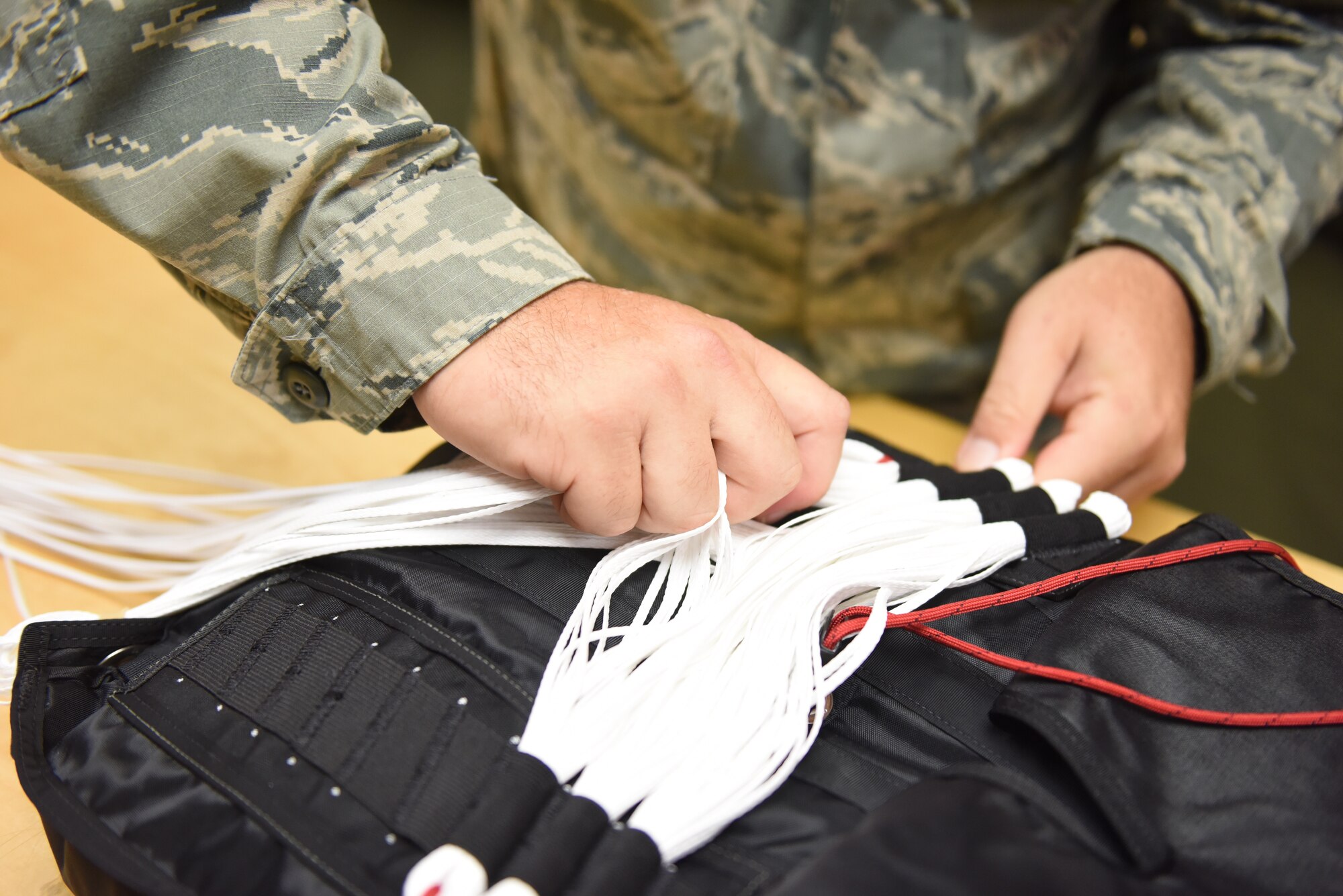 Staff Sgt. Stephen Falker, an aircrew flight equipment technician with the 193rd Special Operations Support Squadron, Middletown, Pennsylvania, Pennsylvania Air National Guard, builds a Low-Profile Parachute from scratch Aug. 9, 2018. The new parachutes replaced the old ones, which were originally constructed in the 1980’s. (U.S. Air National Guard photo by Senior Airman Julia Sorber/Released)