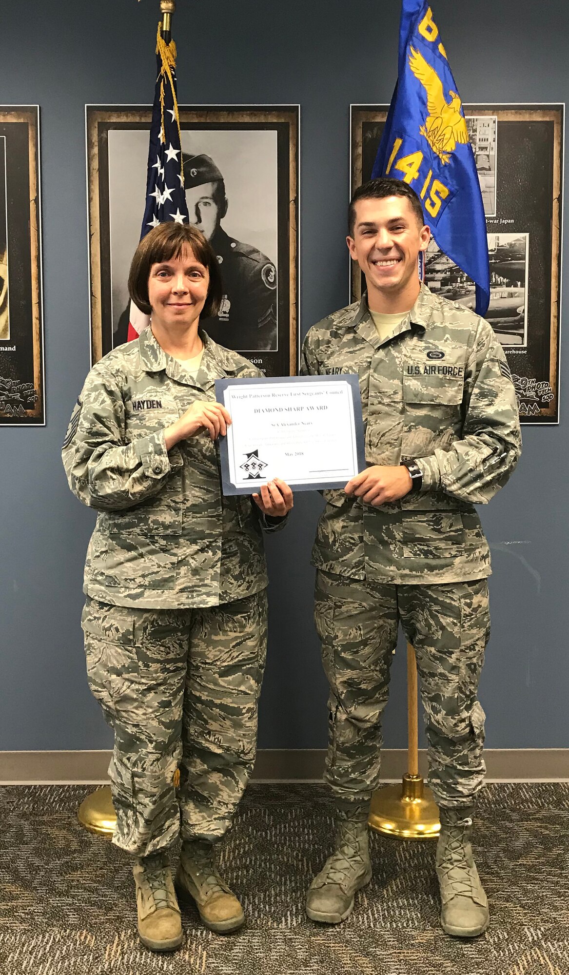 Master Sgt. Angela Hayden, 14th Intelligence Squadron first sergeant, presents the May 2018 Diamond Sharp Award to Senior Airman Alexander Neary, 14 IS operations intelligence journeyman, during the unit training assembly, July 22, 2018.