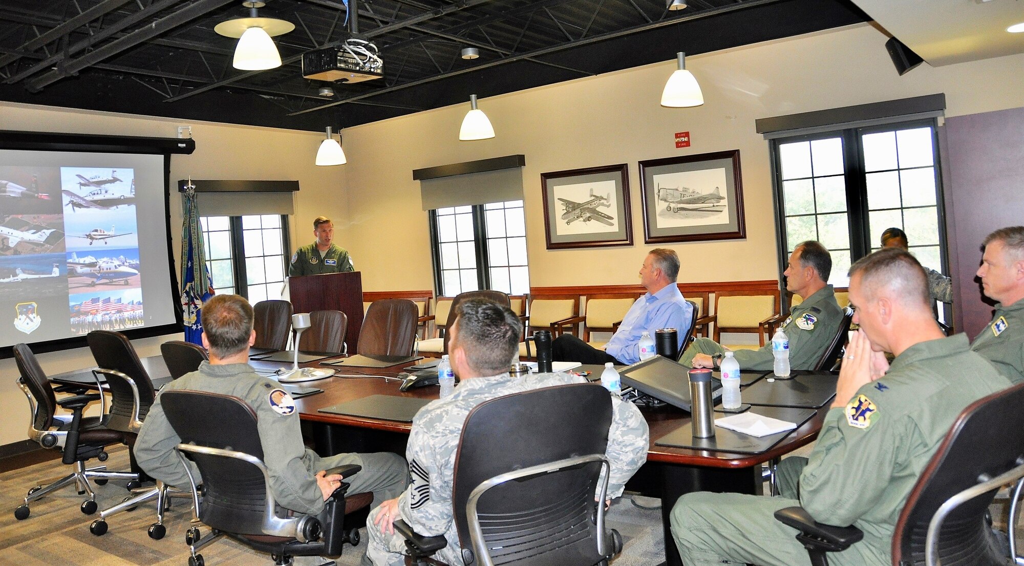 Plans and Programs Chief Lt. Col. James Morgan presents the unit mission brief during 12th FTW Commander Col. Mark Robinson’s Aug. 9 immersion visit to the 340th FTG headquarters at Joint Base San Antonio-Randolph, Texas. (U.S. Air Force photo by Janis El Shabazz)