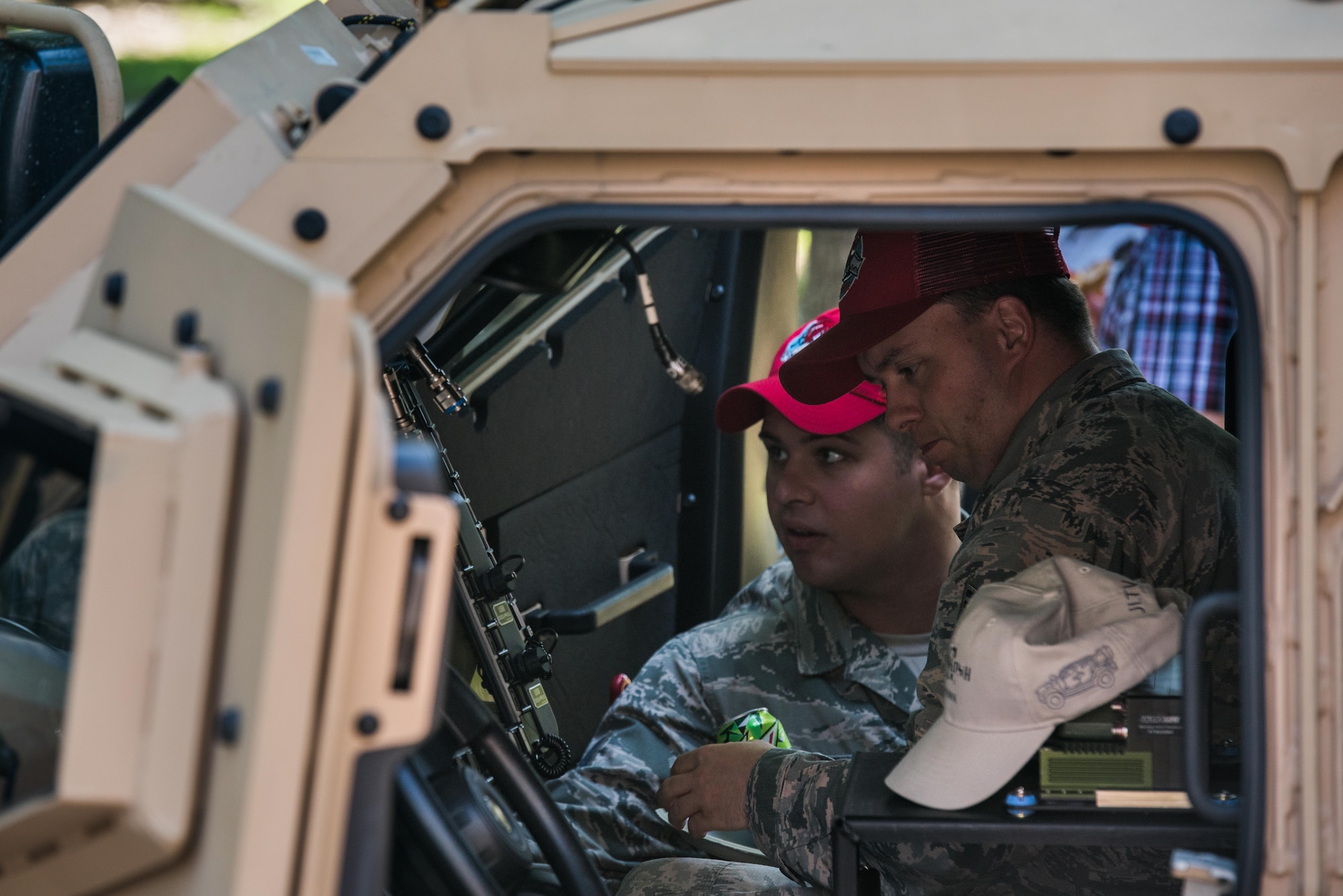 A U.S. Air Force Airmen look in the Joint Light Tactical Vehicle during the Vehicle Transformation and Acquisition Council conference at Joint Base Langley-Eustis, Virginia, Aug. 8, 2018.