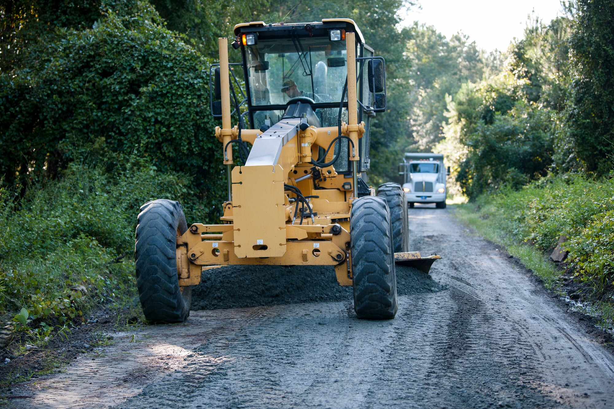 Staff Sgt. David Wakeman, 23d Civil Engineer Squadron (CES) heavy equipment operator, smooths out gravel during A Day In A Life program, Aug. 7, 2018, at Moody Air Force Base, Ga. The initiative is designed to emerge Airmen into the day-to-day activities of the squadron across the 23d CES to foster better connectivity and improve efficiency to save Moody time, money and resources. The ‘dirt boys’ of the 23d CES fix and maintain the integrity and appearance of the runways and roadways around Moody. (U.S. Air Force photo by Airman Taryn Butler)