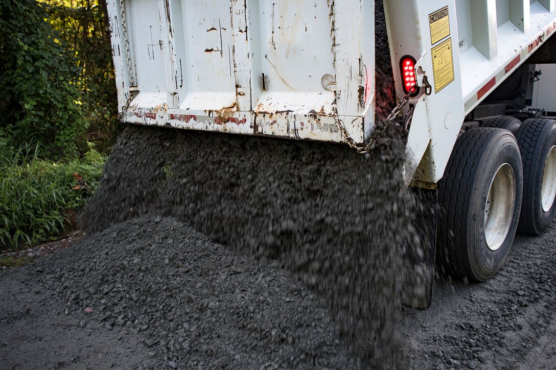 Airmen from the 23d Civil Engineer Squadron (CES) dump gravel on the road during A Day In A Life program, Aug. 7, 2018, at Moody Air Force Base, Ga. The initiative is designed to emerge Airmen into the day-to-day activities of the squadron across the 23d CES to foster better connectivity and improve efficiency to save Moody time, money and resources. The ‘dirt boys’ of the 23d CES fix and maintain the integrity and appearance of the runways and roadways around Moody. (U.S. Air Force photo by Airman Taryn Butler)