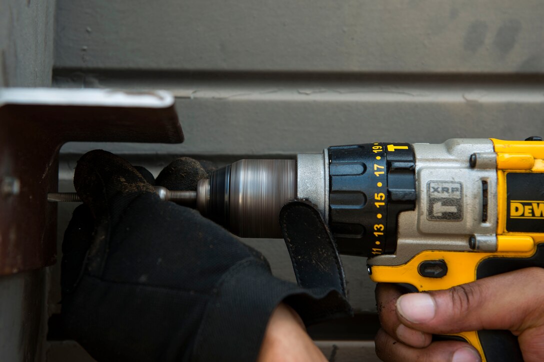 Derrick Burke, 23d Civil Engineer Squadron (CES) installation planner, mounts a bracket during the “A Day In A Life” program, Aug. 6, 2018, at Moody Air Force, Ga. The program challenges participating civil engineers to go behind-the-scenes to perform multiple jobs to better understand their fellow Airmen and better develop operational leaders. The structure shop from the 23d CES maintains the vertical structural integrity of all the facilities on base through painting, locksmithing, welding, metal fabricating and woodworking, along with preventative maintenance on roofs, doors and gates. (U.S. Air Force photo by Airman 1st Class Erick Requadt)