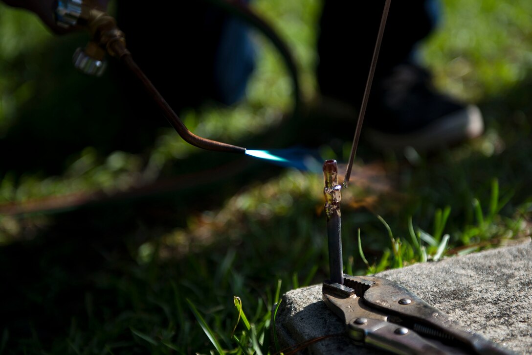 Marshall Maccellan, 23d Civil Engineer Squadron (CES) intern, brazes a copper pipe during the “A Day In A Life” program, Aug. 9, 2018, at Moody Air Force Base, Ga. The program challenges participating civil engineers to go behind-the-scenes to perform multiple jobs to better understand their fellow Airmen and better develop operational leaders. Airmen from the 23d CES who work in the HVAC shop ensure the maintenance and restoration of the heating and cooling equipment around base. (U.S. Air Force photo by Airman 1st Class Erick Requadt)