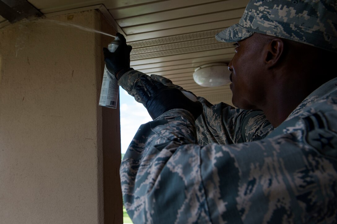 Airman 1st Class Jared King, 23d Civil Engineer Squadron (CES) water and fuel system maintenance apprentice, sprays a wasp nest during the “A Day In A Life” program, Aug. 9, 2018, at Moody Air Force Base, Ga. The program challenges participating civil engineers to go behind-the-scenes to perform multiple jobs to better understand their fellow Airmen and better develop operational leaders. Airmen from the 23d CES who work in the entomology shop specialize in the eradication of species that are prone to carrying vector diseases, along with ensuring the aesthetic upkeep of the landscape on base. (U.S. Air Force photo by Airman 1st Class Erick Requadt)