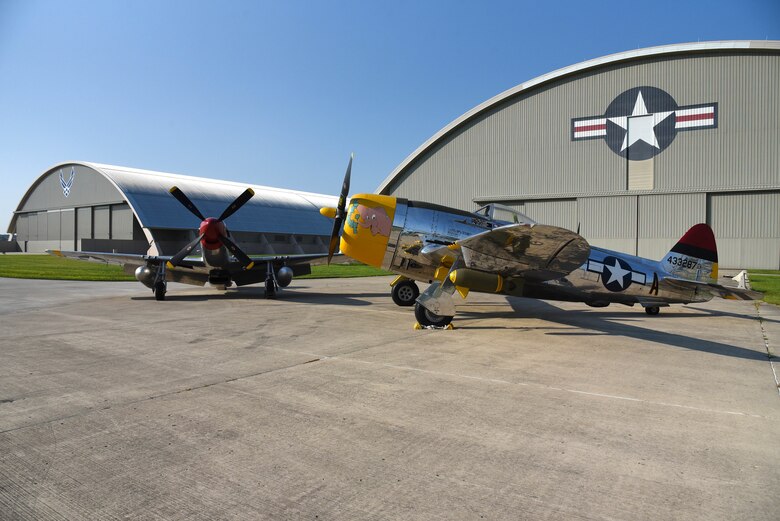 A view of the North American P-51D Mustang and the Republic P-47D (Bubble Canopy Version) before restoration crews at the National Museum of the U.S. Air Force moved the aircraft into the WWII Gallery on Aug. 14, 2018. Several WWII era aircraft on display were temporarily placed throughout the museum to provide adequate space for the Memphis Belle exhibit opening events. (U.S. Air Force photo by Ken LaRock)