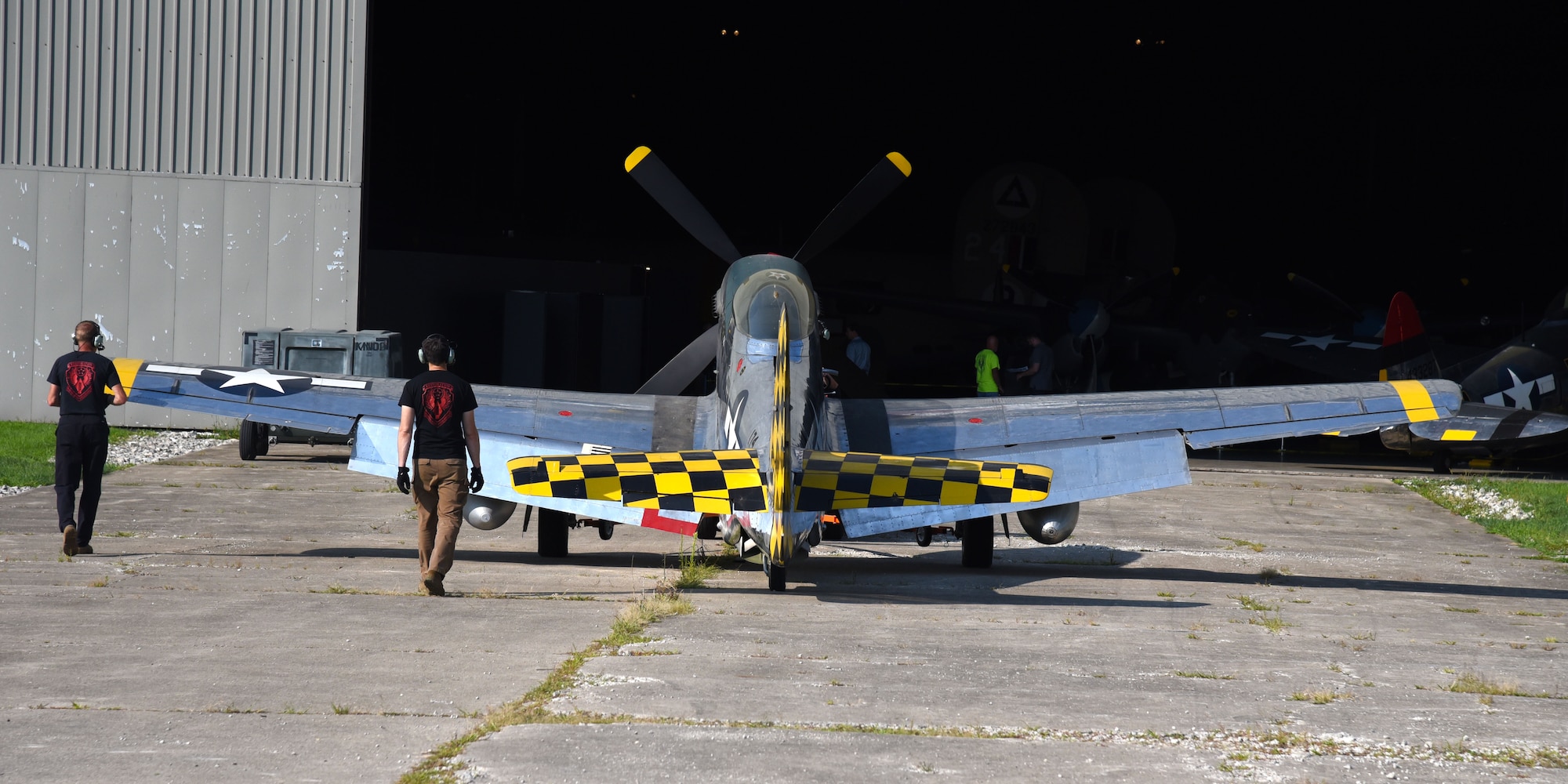 Museum restoration crews move the North American P-51D Mustang back into the WWII Gallery at the National Museum of the U.S. Air Force on Aug. 14, 2018. Several WWII era aircraft were temporarily placed throughout the museum to provide adequate space for the Memphis Belle exhibit opening events. (U.S. Air Force photo by Ken LaRock)