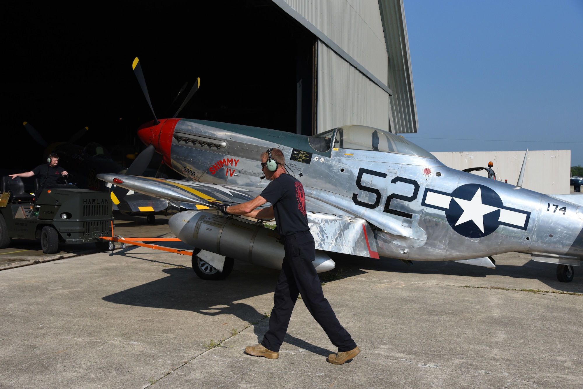 Museum restoration crews move the North American P-51D Mustang back into the WWII Gallery at the National Museum of the U.S. Air Force on Aug. 14, 2018. Several WWII era aircraft were temporarily placed throughout the museum to provide adequate space for the Memphis Belle exhibit opening events. (U.S. Air Force photo by Ken LaRock)