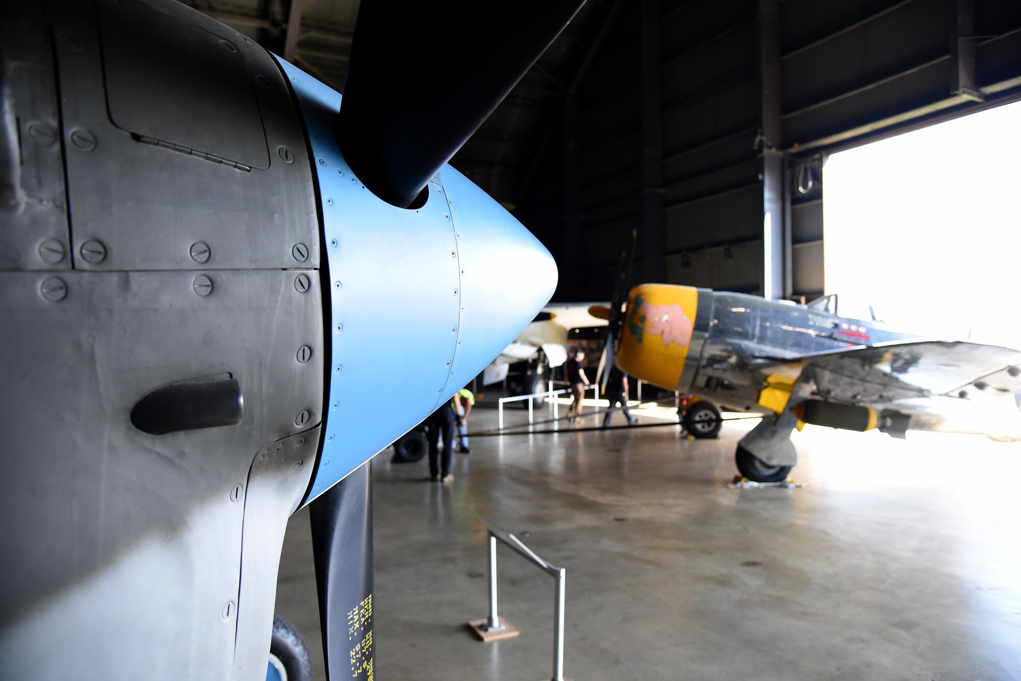 Museum restoration crews move the Republic P-47D (Bubble Canopy Version) back into the WWII Gallery at the National Museum of the U.S. Air Force on Aug. 14, 2018. Several WWII era aircraft were temporarily placed throughout the museum to provide adequate space for the Memphis Belle exhibit opening events. (U.S. Air Force photo by Ken LaRock)