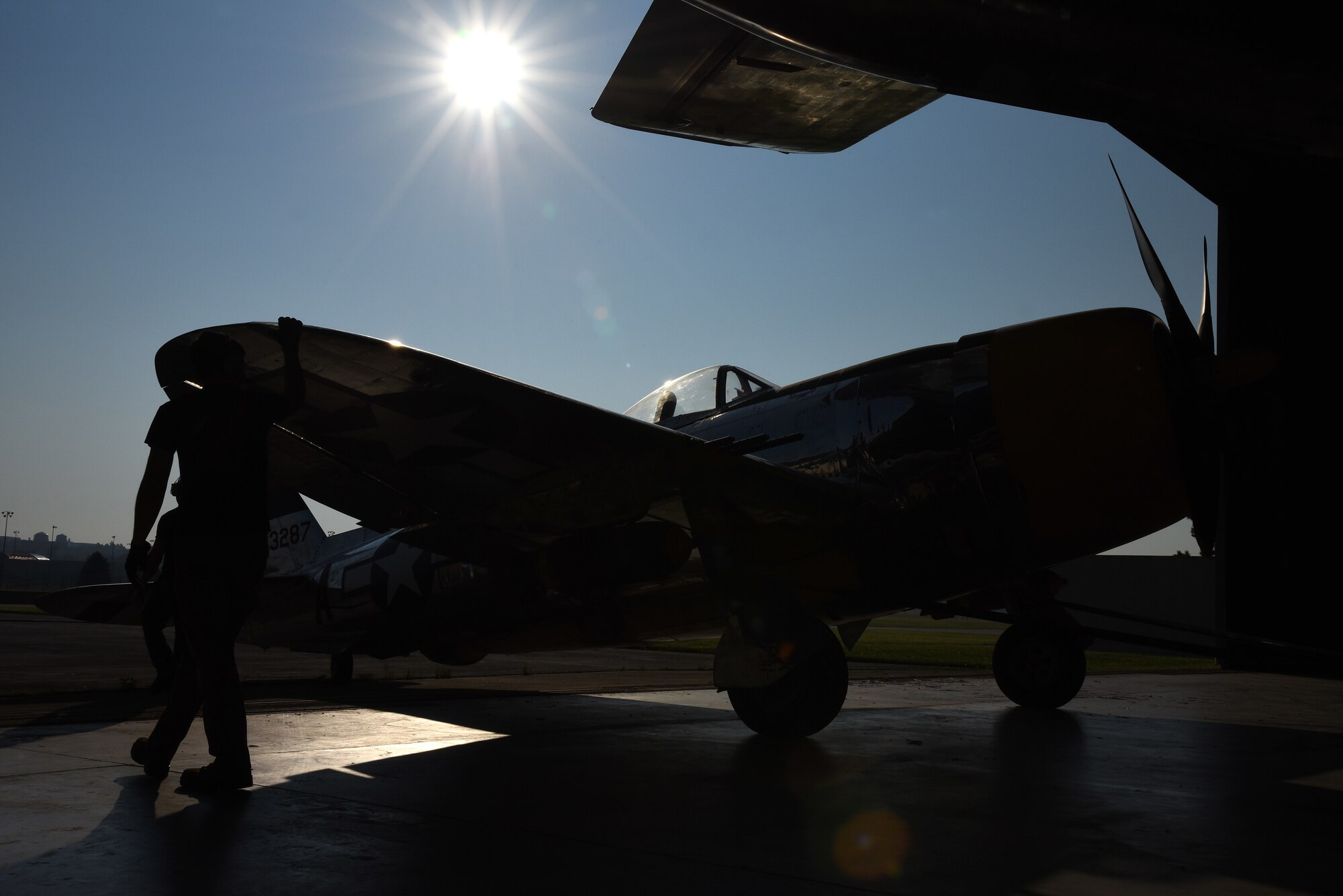 Museum restoration crews move the Republic P-47D (Bubble Canopy Version) back into the WWII Gallery at the National Museum of the U.S. Air Force on Aug. 14, 2018. Several WWII era aircraft were temporarily placed throughout the museum to provide adequate space for the Memphis Belle exhibit opening events. (U.S. Air Force photo by Ken LaRock)