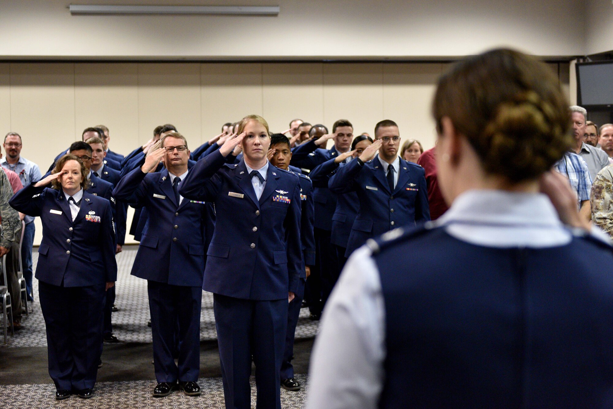 Members of the 17th Training Support Squadron salute U.S. Air Force Lt. Col. Amber Saldaña, 17th TRSS commander, during the 17th TRSS Change of Command in the Event Center on Goodfellow Air Force Base, Texas, August 14, 2018. The change of command ceremony is a time honored military tradition that signifies the orderly transfer of authority. (U.S. Air Force photo by Senior Airman Randall Moose/Released)