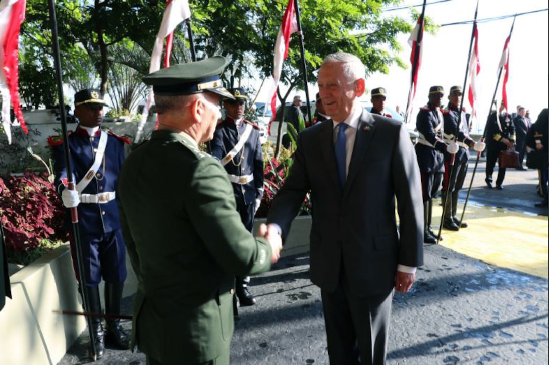 Defense Secretary James N. Mattis shakes hands with a Brazilian defense official.