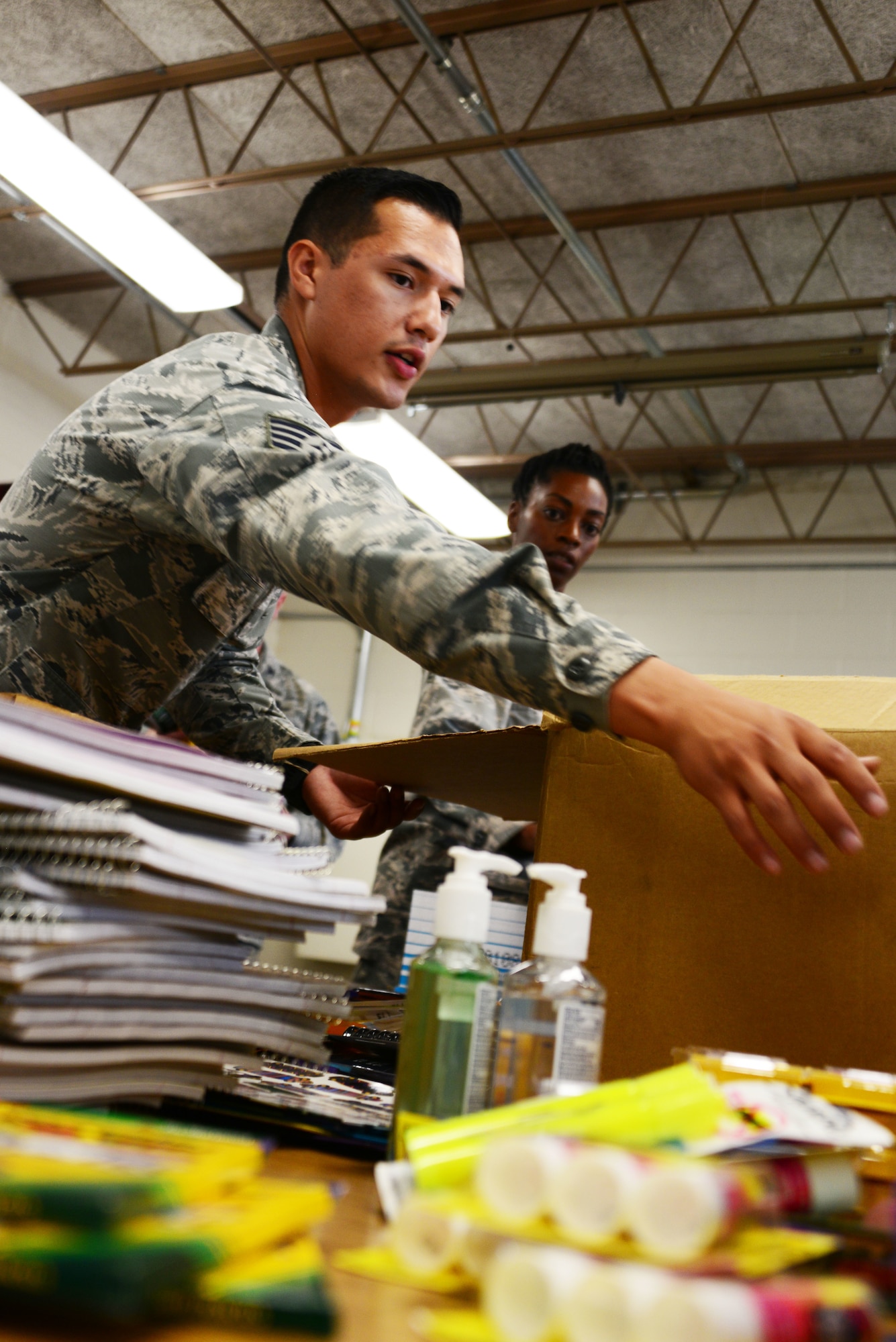 Staff Sgt. Isaiah Galvan and other members of the Space and Missile Systems Center’s Advanced Systems and Development Directorate sort through donated school supplies during a school supply drop at Kirtland Elementary School here Aug. 10. Galvan and other members of SMC AD dropped 1020 lbs. of supplies donated by the Kirtland community. The drive is conducted annually by local units under AFSPC. (U.S. Air Force photo by Jessie Perkins)