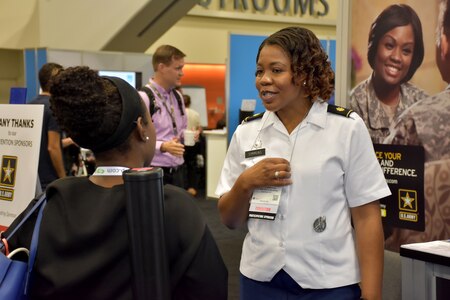 Maj. Lakishia M. Simmons, San Francisco Medical Recruiting Station officer-in-charge, speaks with an attendee of the American Psychological Association 2018 Convention at the Moscone Center in San Francisco, California on August 9. Simmons was on hand with her team to explain the benefits and opportunities of a career in Army Medicine. For more information on the Army's more than 90 medical specialties go to healthcare.goarmy.com.