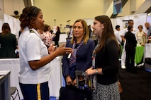 Maj. Lakishia M. Simmons, San Francisco Medical Recruiting Station officer-in-charge, speaks with a convention attendee and her parent at the American Psychological Association 2018 Convention held at the Moscone Center in San Francisco, California on August 9. Simmons was on hand with her healthcare recruiting team to explain the benefits and opportunities of a career in Army Medicine. For more information on the Army's more than 90 medical specialties go to healthcare.goarmy.com.