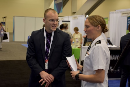 Capt. Emily Burris, clinical psychology resident with Brooke Army Medical Center, speaks with an attendee of the American Psychological Association 2018 Convention at the Moscone Center in San Francisco, California on August 9. Burris was on hand with Soldiers from the San Francisco Medical Recruiting Station to explain the benefits and opportunities of a career in Army Medicine. For more information on the Army's more than 90 medical specialties go to healthcare.goarmy.com.