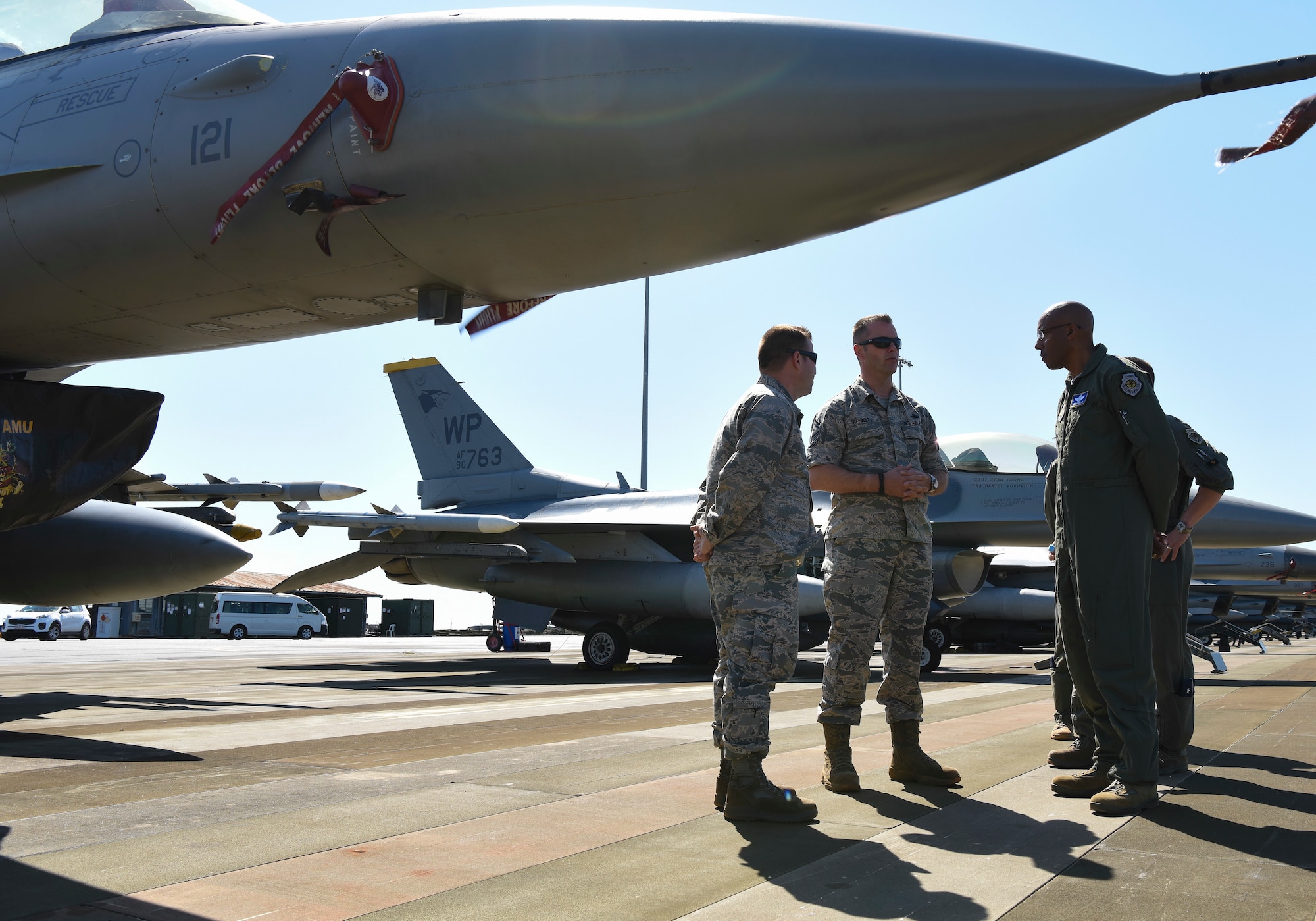 U.S. Air Force Gen. CQ Brown, Jr., Pacific Air Forces commander (right), speaks with Senior Master Sgt. Eric Bennett (middle), 80th Aircraft Maintenance Unit superintendent, and Capt. Donovan Ricks (left), 80th AMU officer in charge, during Exercise Pitch Black 2018, at Royal Australian Air Force Base Darwin, Australia, Aug. 13, 2018. Brown, who started his career at Kunsan Air Base, Republic of Korea, visited with participating Airmen from the 8th Fighter Wing. (U.S. Air Force Photo by Senior Airman Savannah Waters)