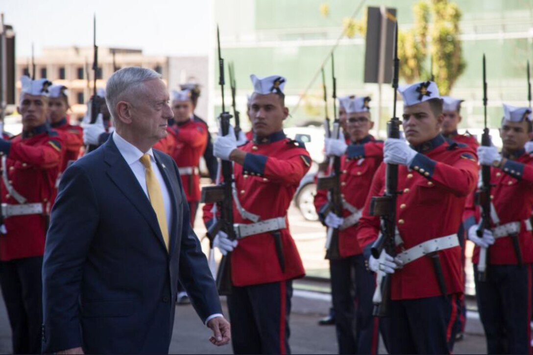 Defense Secretary James N. Mattis walks by Brazilian troops.