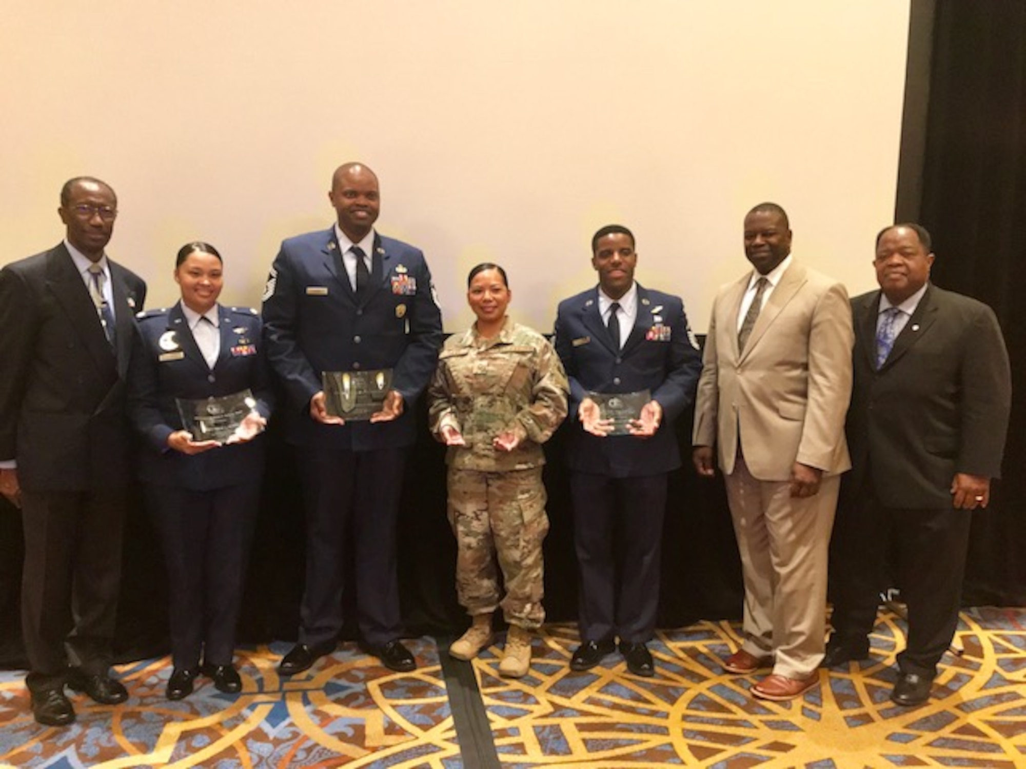 Master Sgt. Josefina Liles, 380th Security Forces Squadron force protection intelligence analysist, (center) shows her award with other Tuskegee Airman Inc. award winners at the 47th Annual Tuskegee Airmen National Convention in Las Vegas, Nevada, Aug. 9. Liles was awarded the Senior Master Sergeant Margaret Frances Barbour, NCO Military Award. (Courtesy photo)