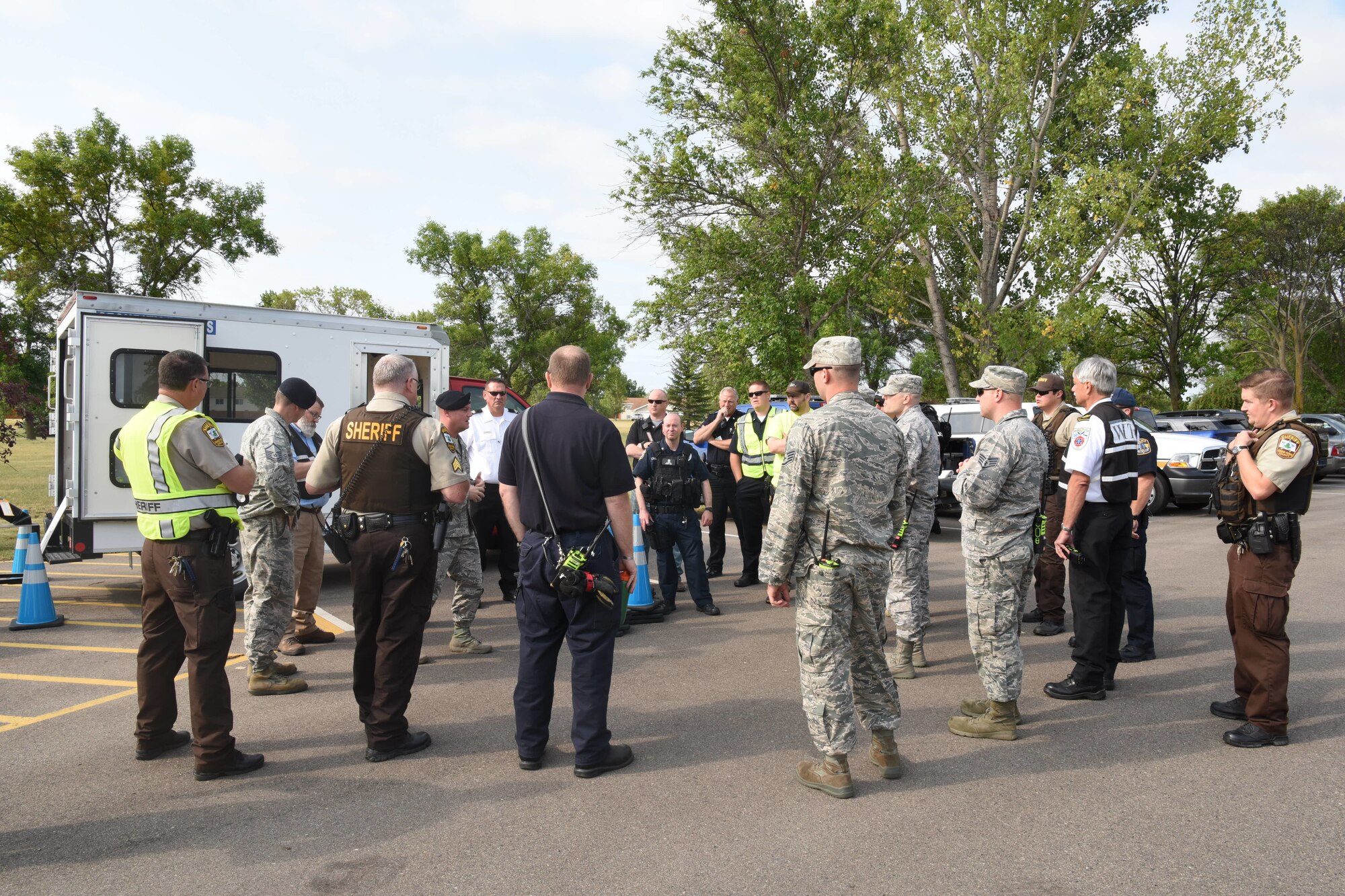 Grand Forks Air Force Base and local law enforcement rally to discuss events of an active-shooter exercise August 14, 2018, on Grand Forks Air Force Base, North Dakota. The exercise was a collaborative effort between the Grand Forks AFB law enforcement and medical units, Grand Forks County law enforcement, and the Grand Forks Public School administration. (U.S. Air Force photo by Senior Airman Elijaih Tiggs)