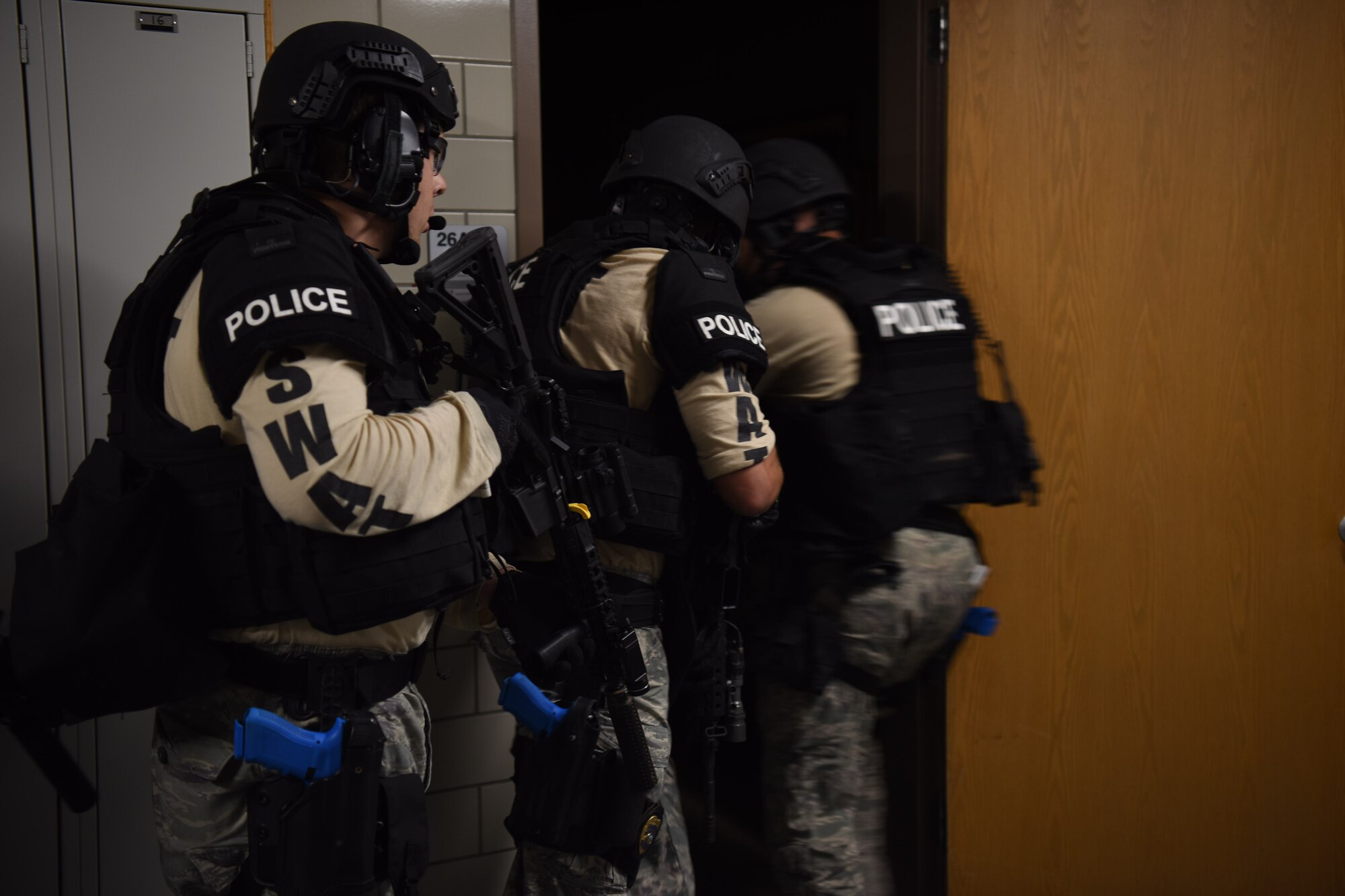 Law enforcement teams practice first-responder duties during an active-shooter exercise August 14, 2018, on Grand Forks Air Force Base, North Dakota. The exercise paired law enforcement and medical units in order to conduct security tactics with rescue actions for wounded exercise participants. (U.S. Air Force photo by Senior Airman Elijaih Tiggs)