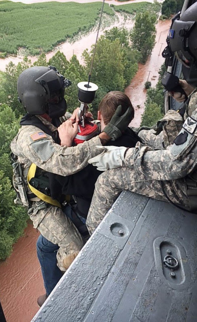 U.S. Soldiers with the 28th Expeditionary Combat Aviation Brigade, Pennsylvania Army National Guard, rescue a person stranded by flooding near Benton, Pennsylvania, Aug. 13, 2018.