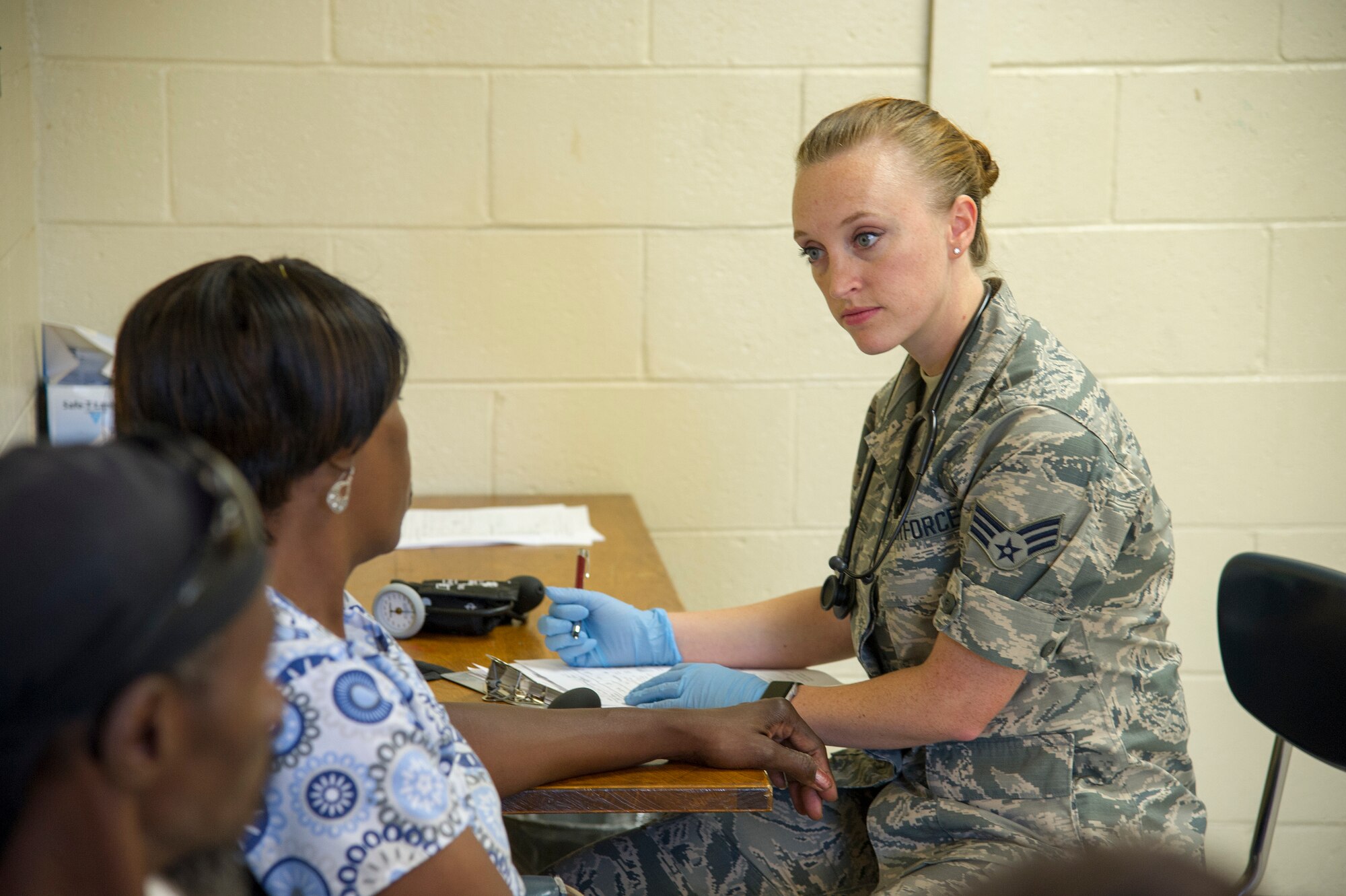 U.S. Air Force Senior Airman Erin Berry, of Winchester, Va., a medical technician with the West Virginia Air National Guard’s 167th Medical Group, Martinsburg, W.Va., conducts an initial health screening with local residents in Millen, Ga., July 14, 2018, during the East Central Georgia Innovative Readiness Training. An IRT provides hands-on, real-world training to improve readiness and interoperability for service members in complex contingency environments while providing key services for American communities. (U.S. Air Force photo by Master Sgt. Theanne Herrmann)