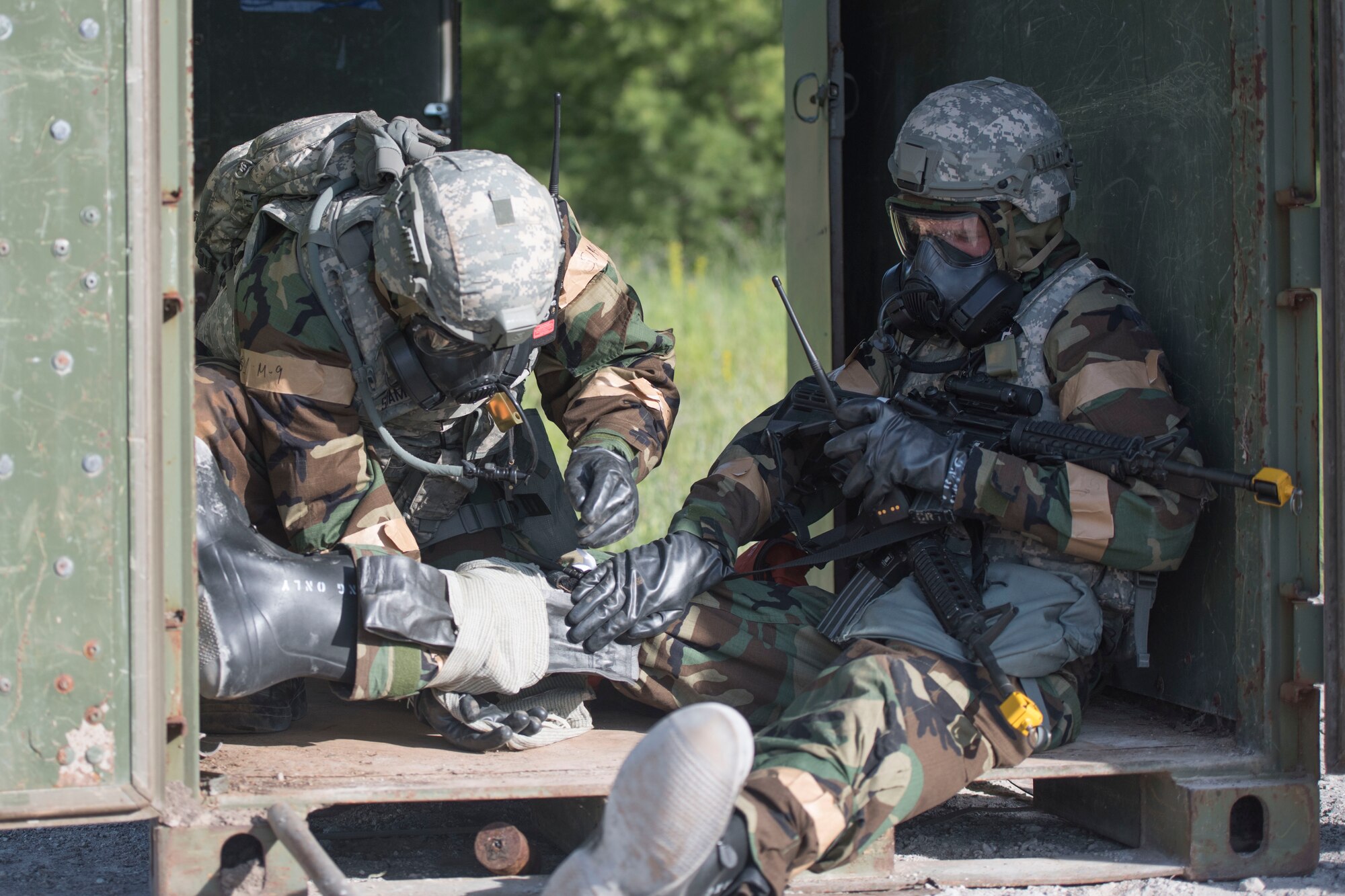 Two Airmen assigned to the 167th Security Forces Squadron use self-aid and buddy care skills to splint a leg during a deployment training exercise at the Alpena Combat Readiness Training Center in Michigan, June 10-14, 2018. Approximately 200 members of the 167th Airlift Wing participated in the event. (U.S. Air National Guard photo by Tech. Sgt. Jodie Witmer)
