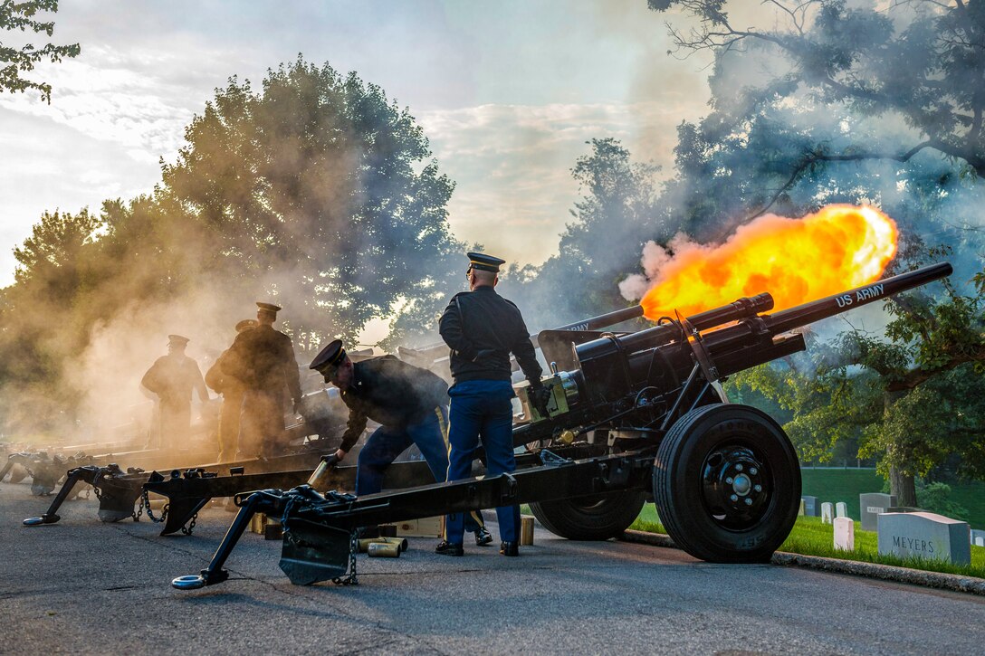 Soldiers fire blanks from cannons.