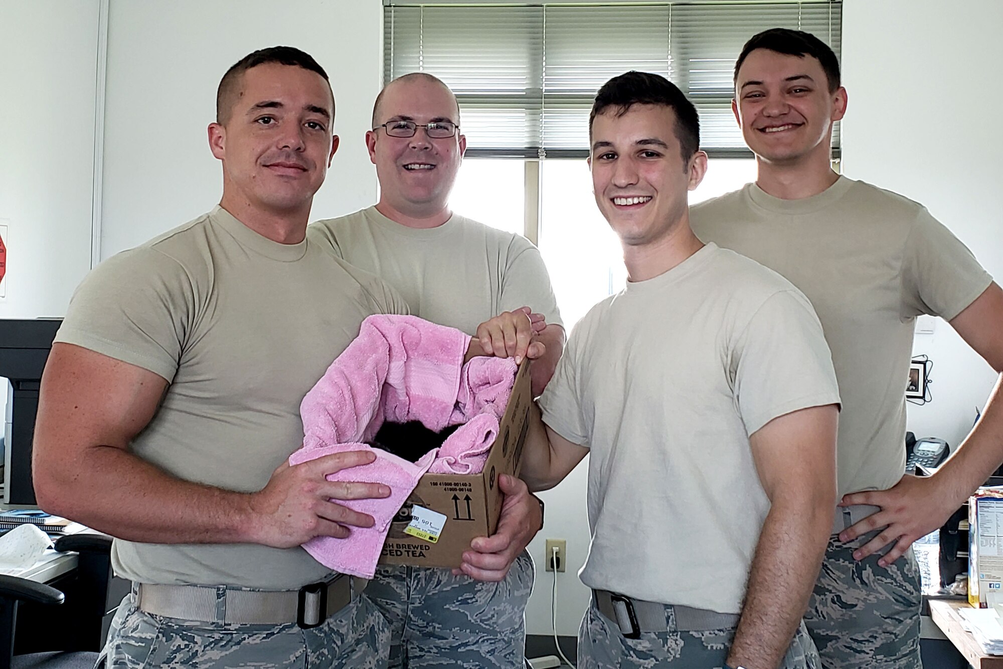 Fuels specialists for the 167th Airlift Wing, Airman 1st Class Zachary Langhorne, Master Sgt. Christopher Whiteside, Staff Sgt. Phillip Wingerd and Airman 1st Class Andrew Stover display a box holding four kittens that were found in a hose reel of a fueling truck while the truck was refueling a C-17 Globemaster aircraft at the Martinsburg, W.Va. air base, June 19, 2018. The kittens eventually found homes with 167th AW Airmen.