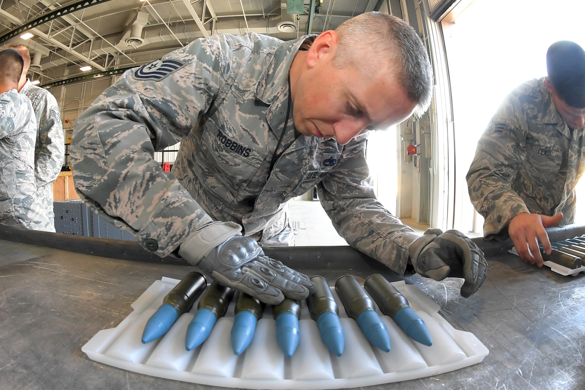 Tech. Sgt. Ross Robbins, 419th Maintenance Squadron, inspects 25 mm target practice rounds in preparation for loading into F-35 magazines August 8, 2018 at Hill Air Force Base, Utah. The F-35A is the only F-35 variant with an internal cannon. It is capable of firing 50 rounds per second. (U.S. Air Force photo by Todd Cromar)