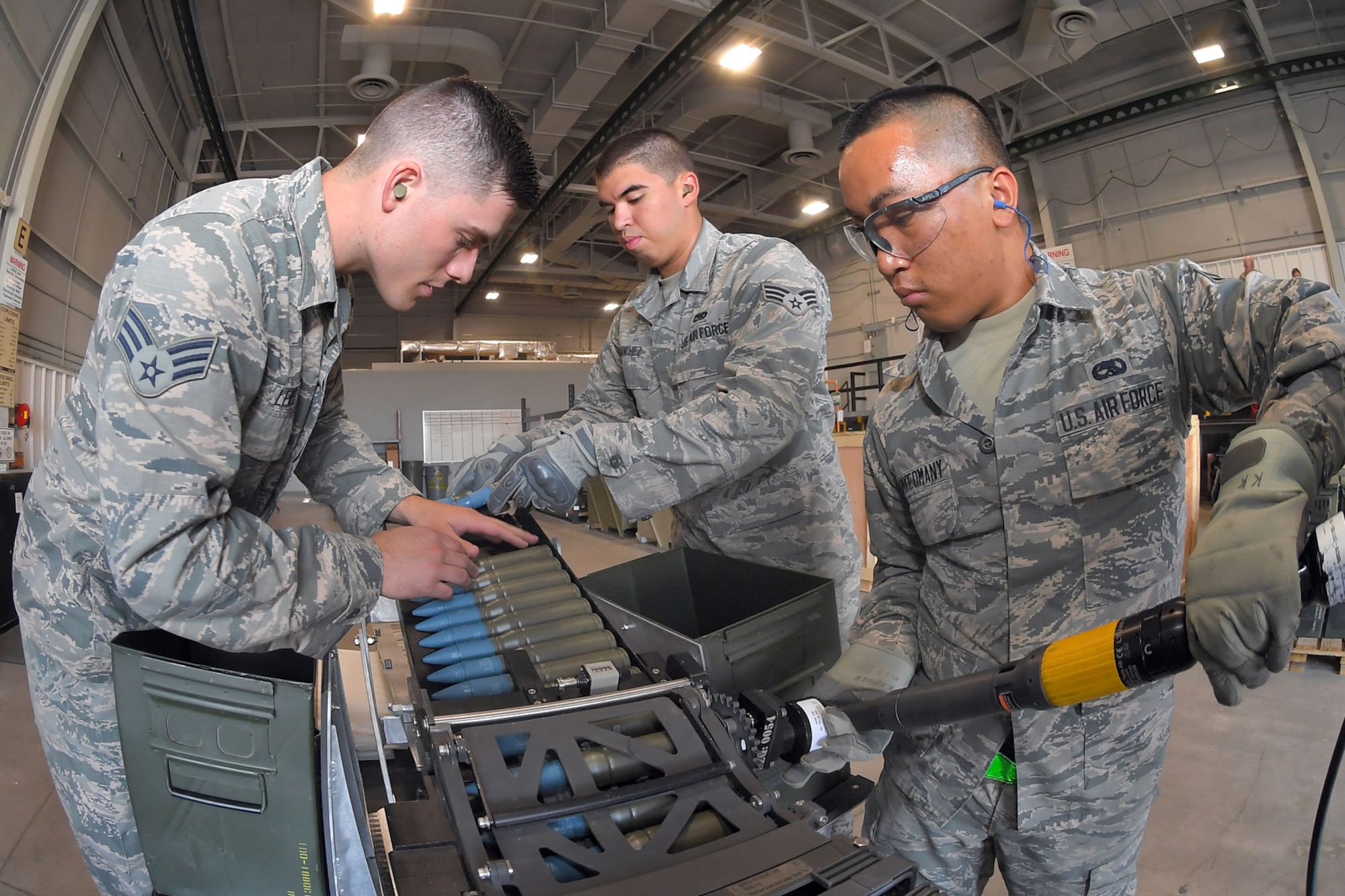 Senior Airman Bradley Lewis, Senior Airman Nicholas Sanchez, and Airman 1st Class James Khamkeomany, 388th Maintenance Squadron, load 25 mm target rounds into F-35 magazines August 8, 2018, Hill Air Force Base, Utah. The training was in preparation for the first operational loading of the F-35A cannon. (U.S. Air Force photo by Todd Cromar)