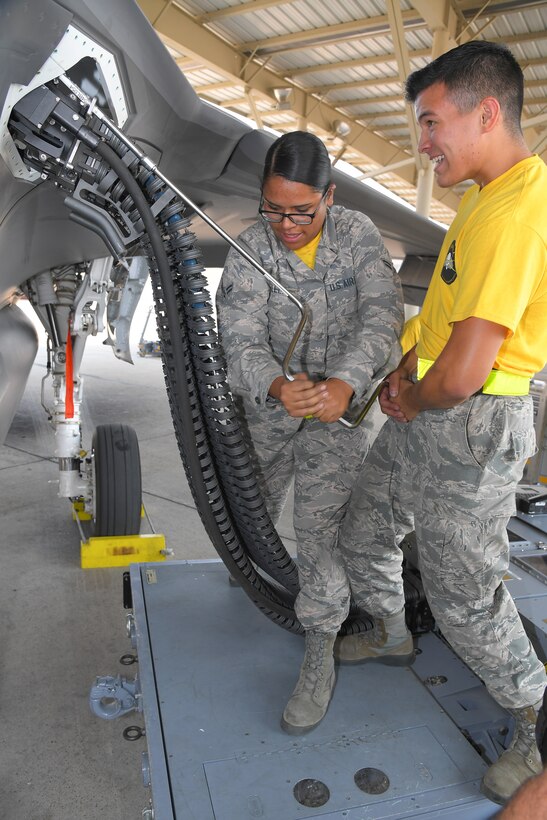 Airman 1st Class Emily Villela and Airman Baltazar Enriquez, 4th Aircraft Maintenance Unit, accomplish the first-time operational loading of 25 mm target rounds in an F-35A Lightning II,  Aug. 10, 2018, at Hill Air Force Base, Utah. (U.S. Air Force photo by Todd Cromar)
