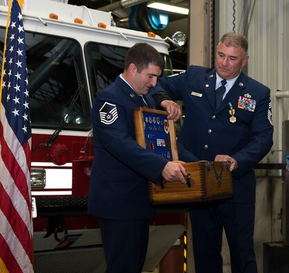 Chief Master Sgt. Anthony M. Lebel, vehicle fleet manager assigned to the 157th Mission Support Group, receives his shadow box from Master Sgt. Christian M. Swegles, a mission generation vehicular equipment mechanic assigned to the 157th MSG,  during a ceremony on Aug. 11, 2018 at Pease Air National Guard Base, N.H. Lebel joined the Air Force  in 1983 and retired after more than 35 years of service. (Photo by Staff Sgt. Kayla White, 157th Air Refueling Wing Public Affairs)