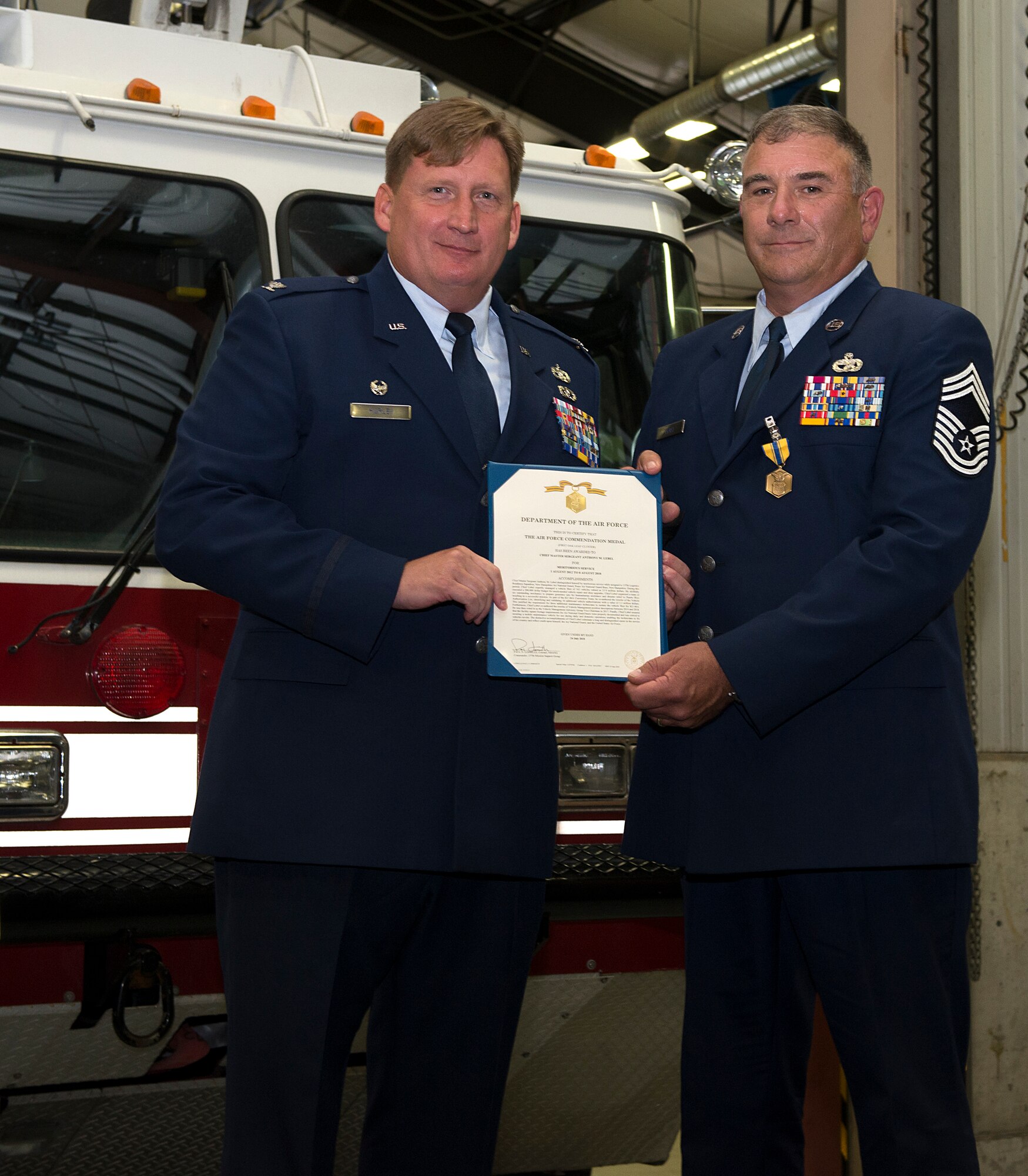 Chief Master Sgt. Anthony M. Lebel, vehicle fleet manager assigned to the 157th Mission Support Group, receives his retirement certificate from Col. Christopher W. Hurley, commander of the 102nd MSG, Vermont Air National Guard, during a ceremony on Aug. 11, 2018 at Pease Air National Guard Base, N.H. Lebel joined the Air Force  in 1983 and retired after more than 35 years of service. (Photo by Staff Sgt. Kayla White, 157th Air Refueling Wing Public Affairs)
